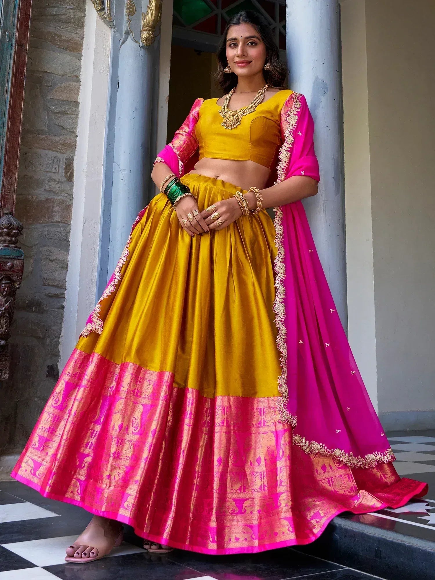 Yellow and pink designer lehenga choli with gold embroidery, perfect for Indian ethnic wear events