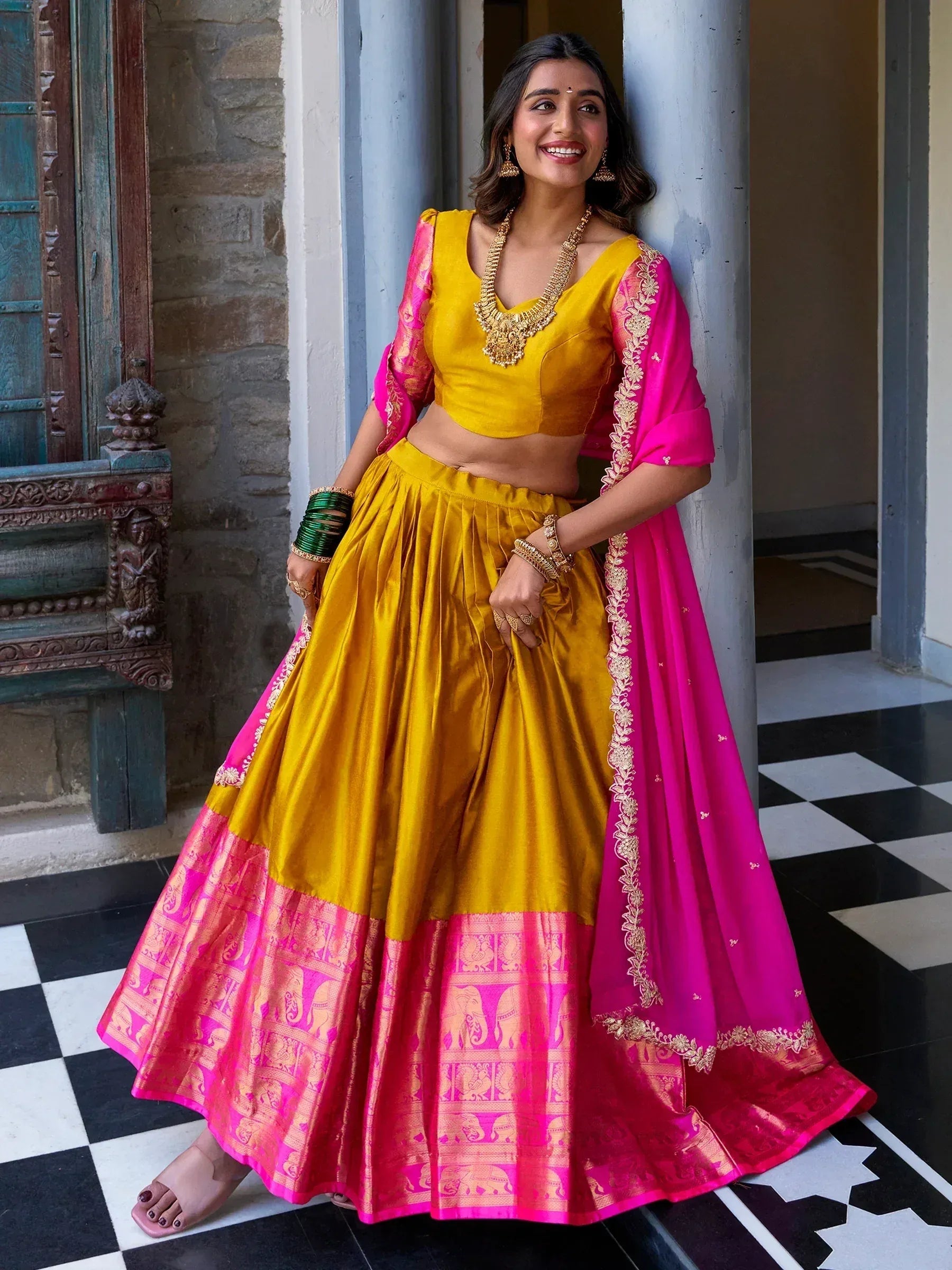 Yellow and pink designer lehenga choli with gold embroidery, perfect for Indian ethnic wear occasions