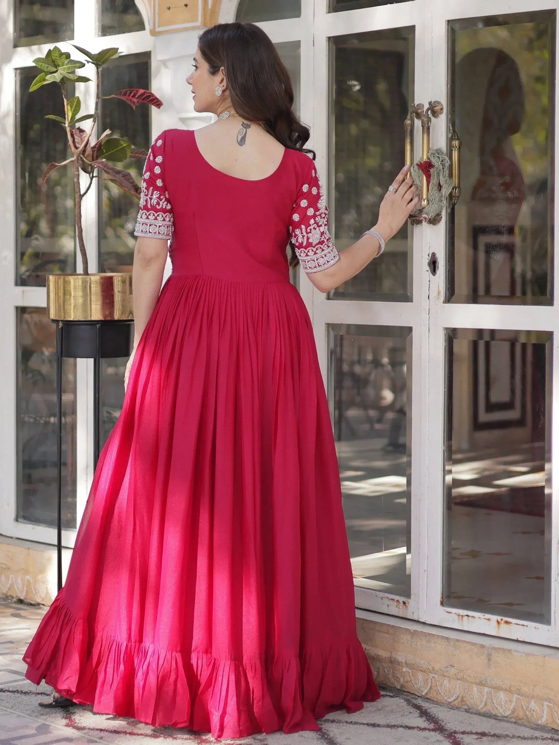 Red ethnic gown with white embroidery, pleated skirt, and ruffle hem for Indian occasions