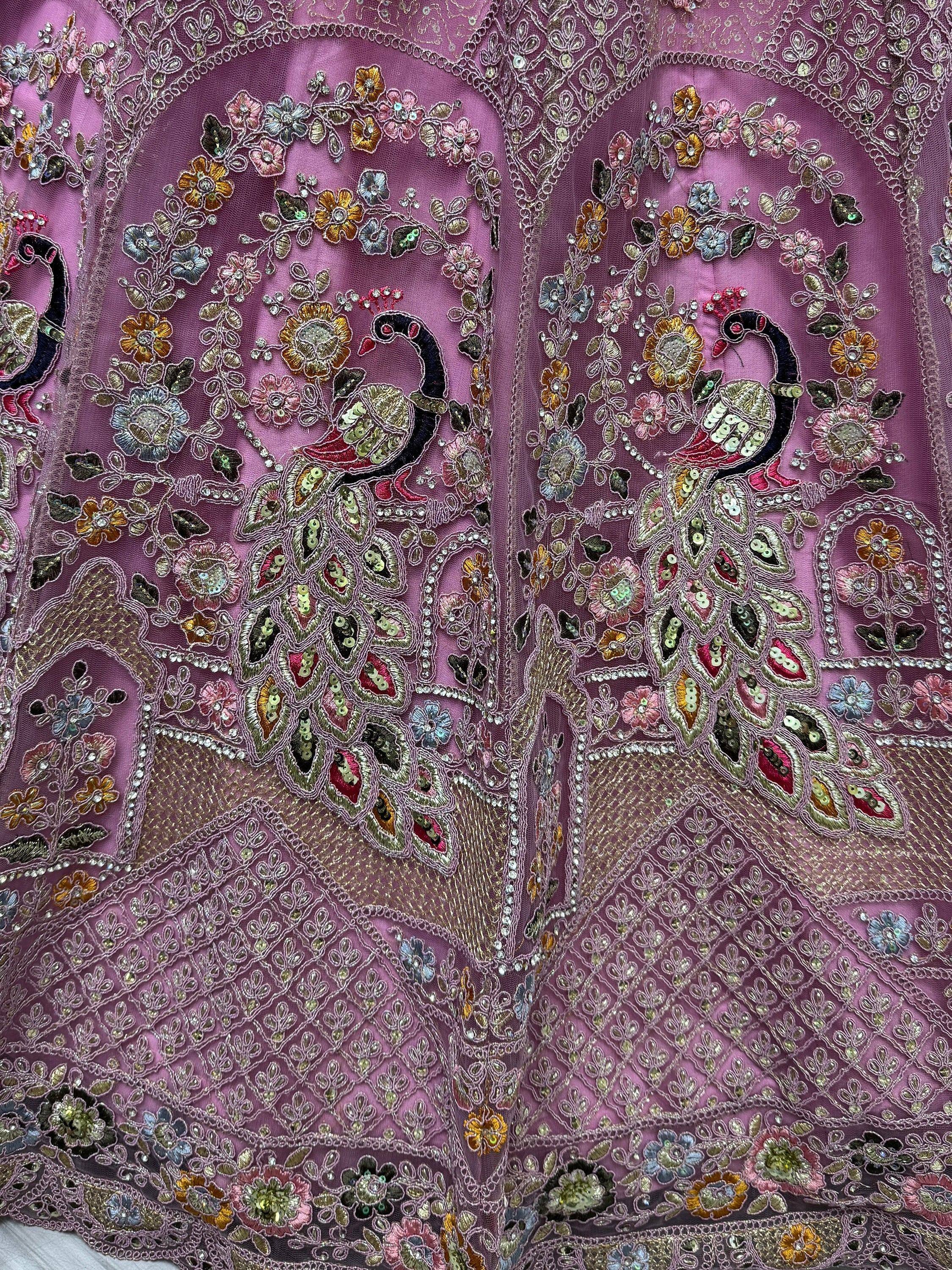 Purple ethnic wear with peacock embroidery, floral sequins, and intricate beadwork for festive occasions