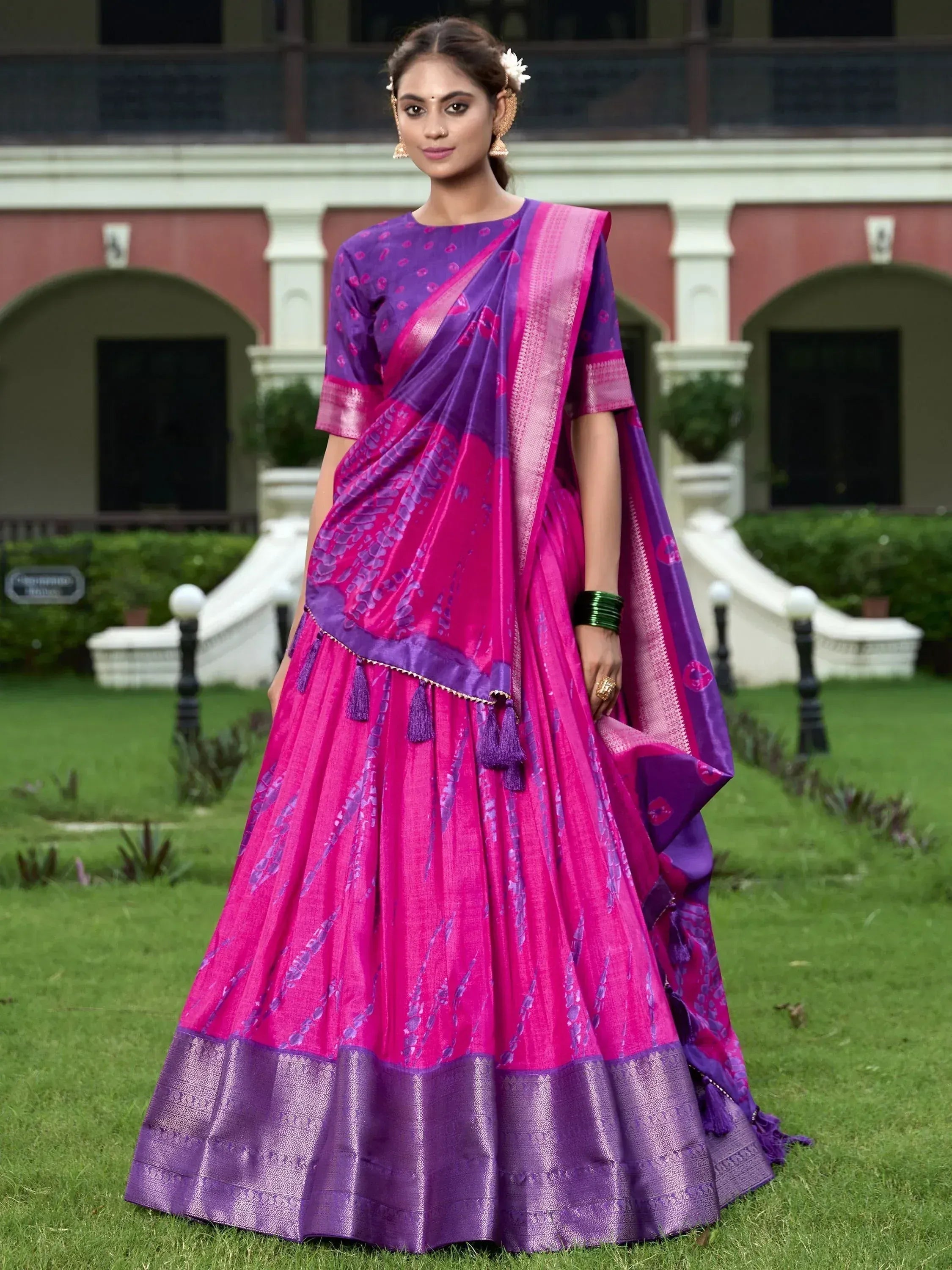 Vibrant pink and purple designer lehenga choli with tassels, perfect for Indian ethnic occasions
