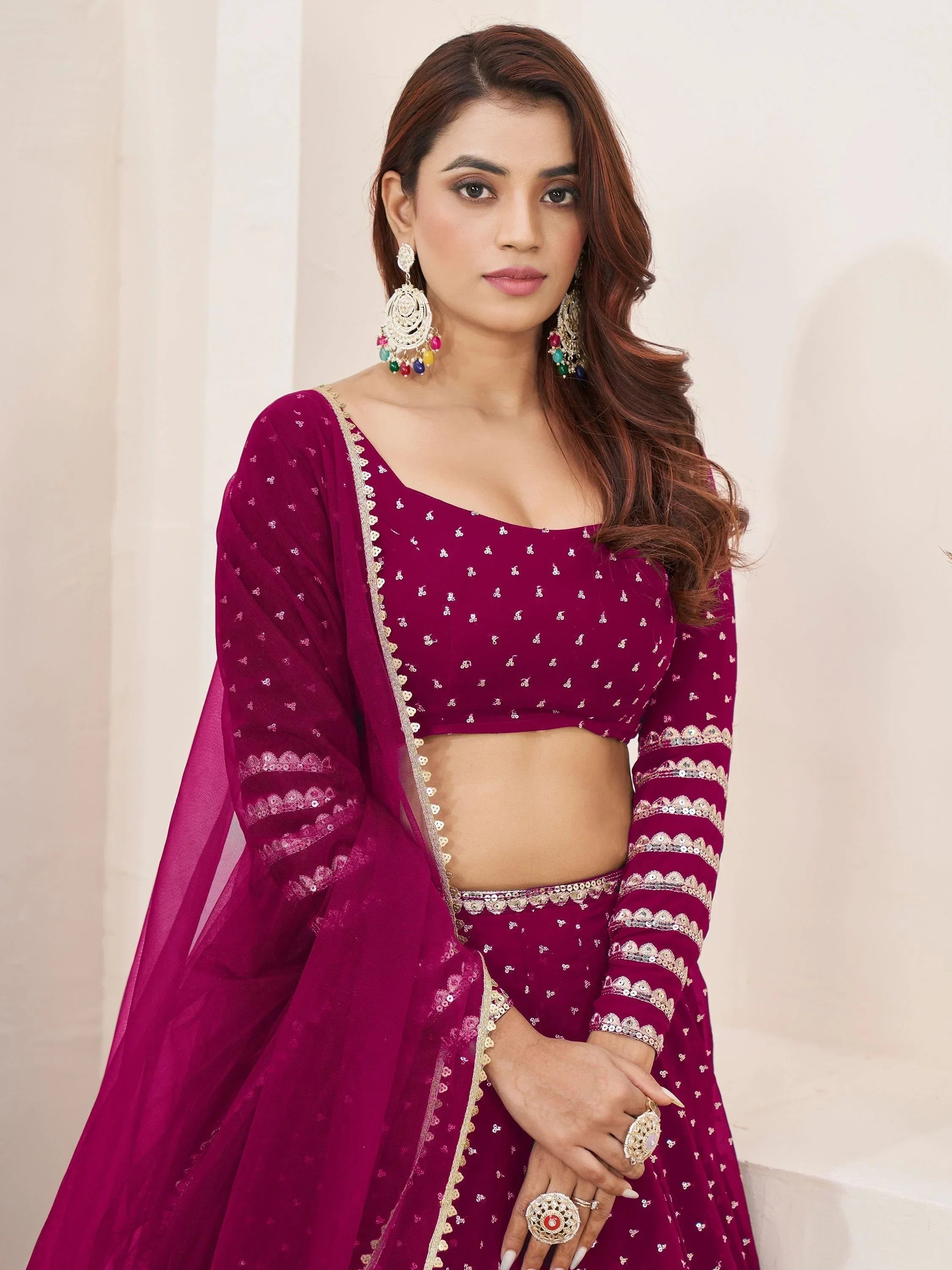 Elegant maroon Indian lehenga choli with gold embroidery and sequins, perfect for weddings and festive occasions.