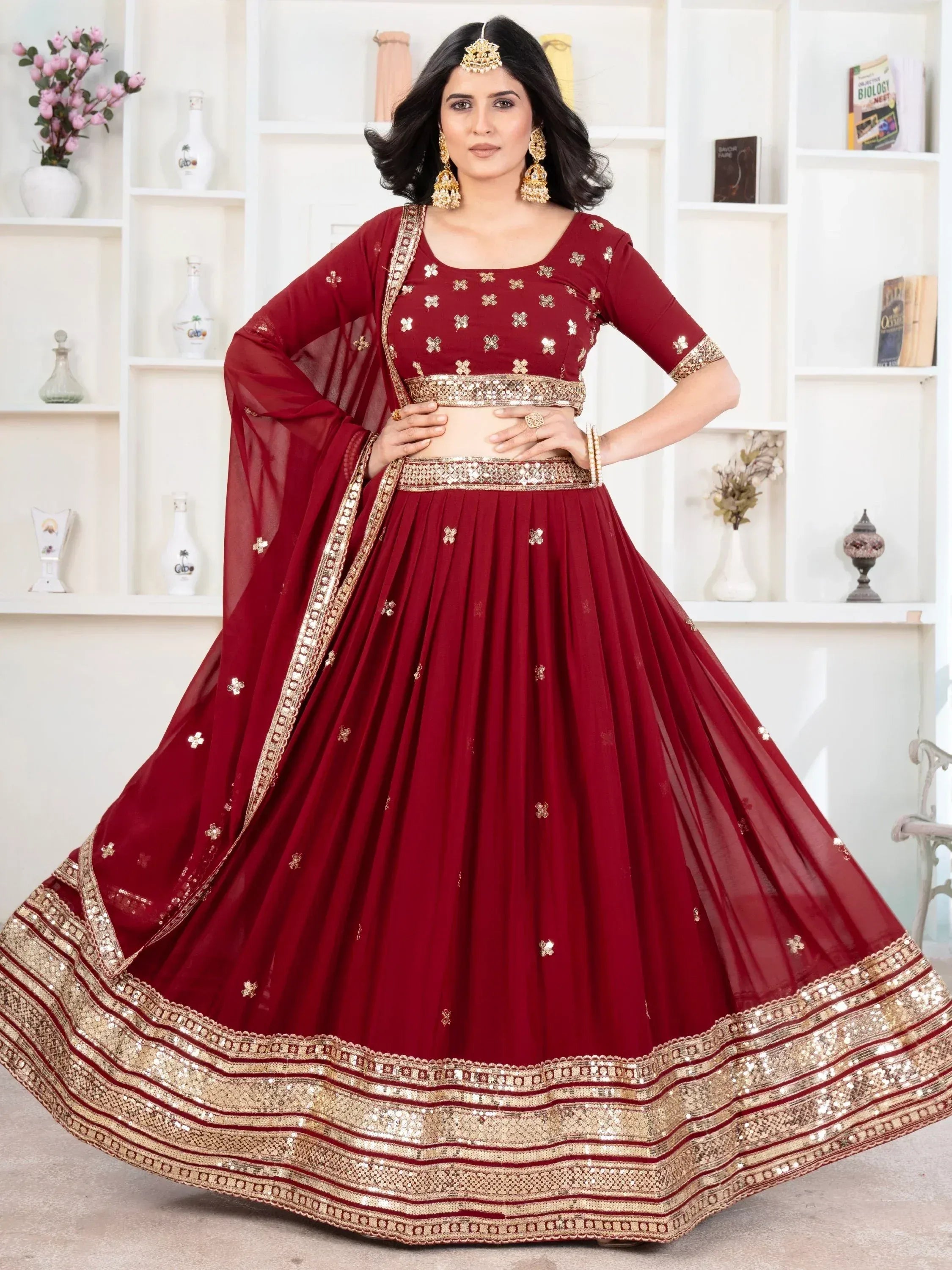 Maroon designer lehenga choli with gold embroidery and sequin border, perfect for Indian ethnic wear occasions