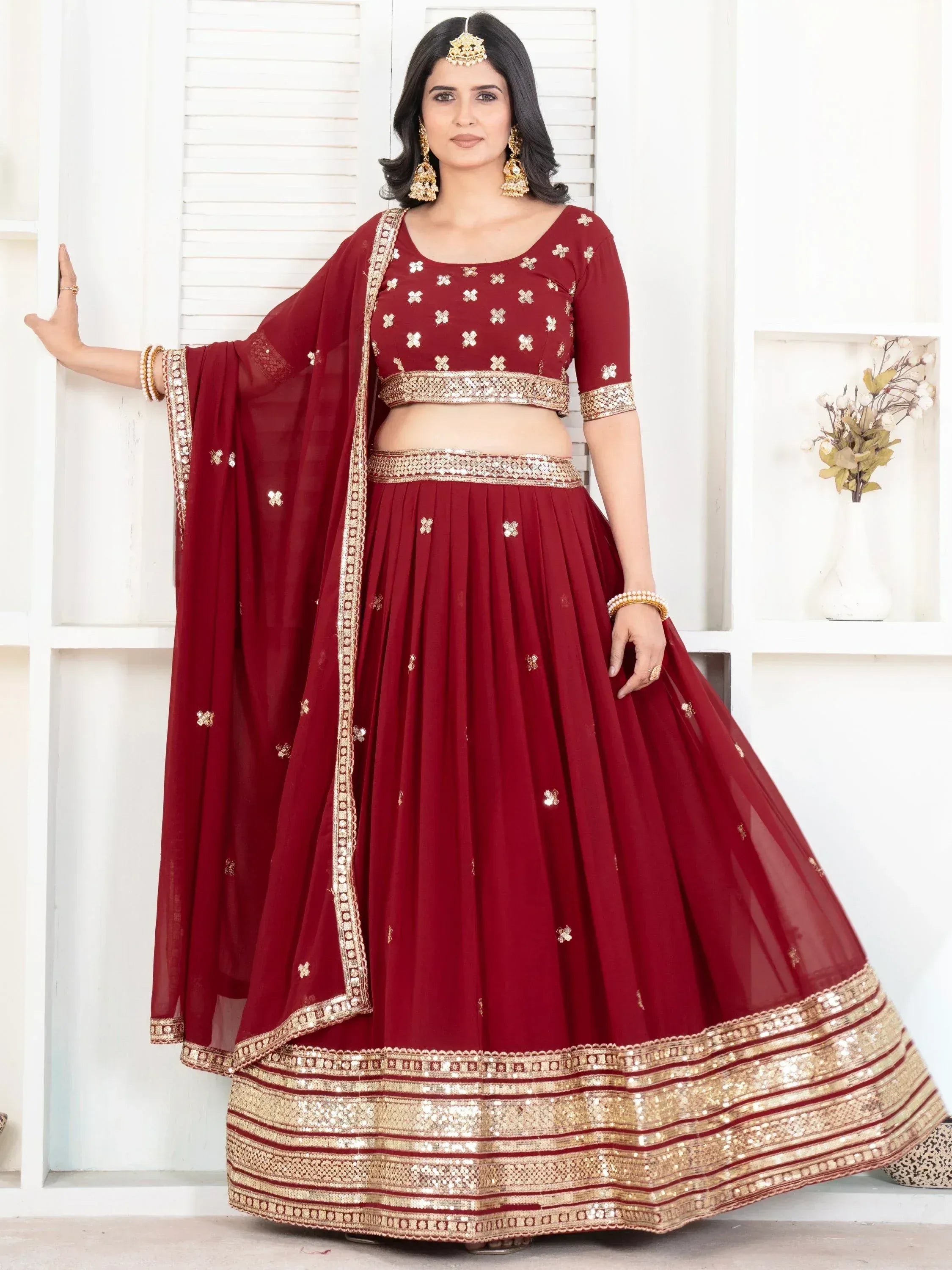 Maroon lehenga choli with gold embroidery and sequin border, perfect for Indian ethnic wear occasions