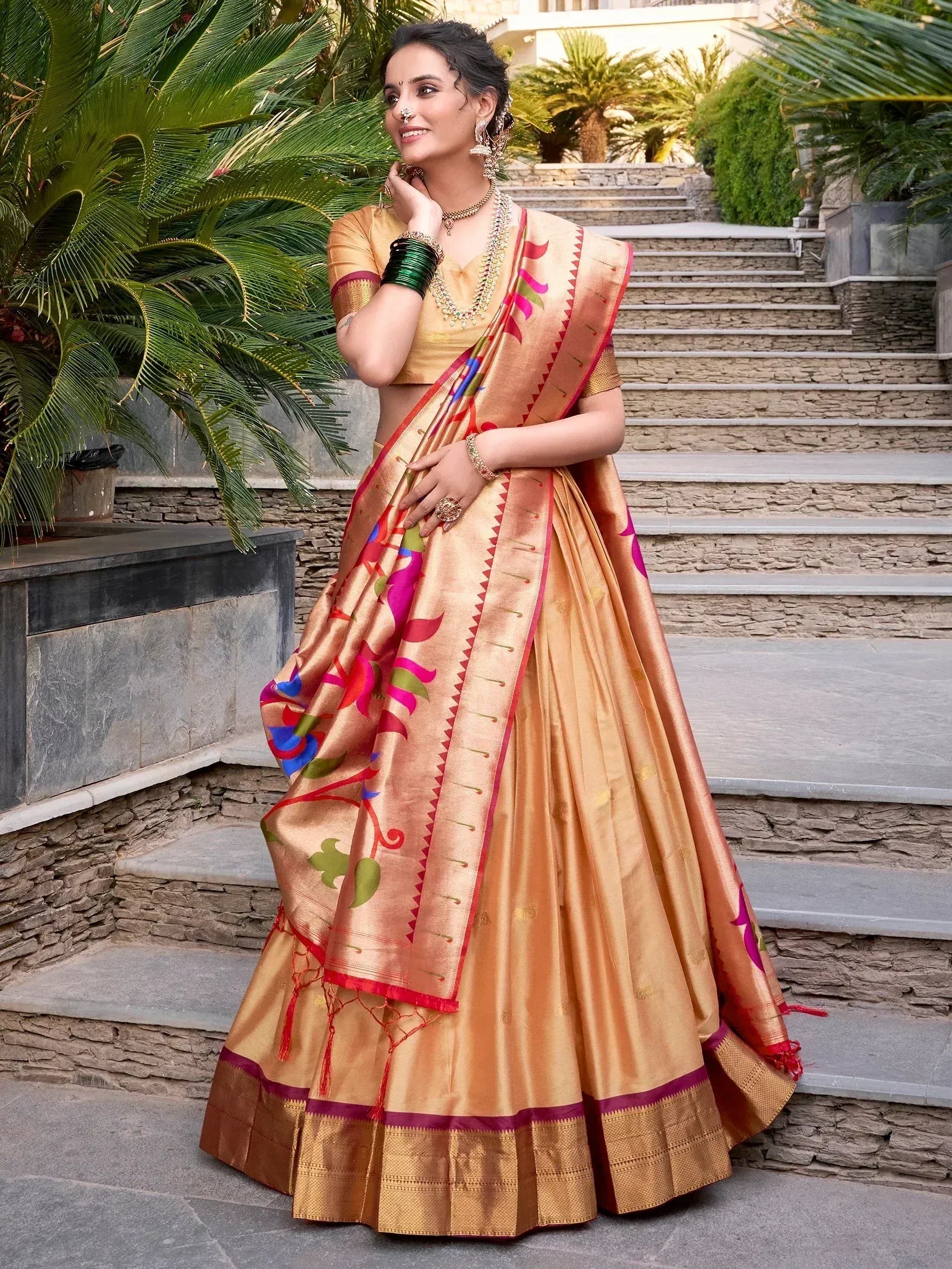 Woman in golden designer lehenga choli with colorful floral print, perfect for Indian ethnic wear occasions