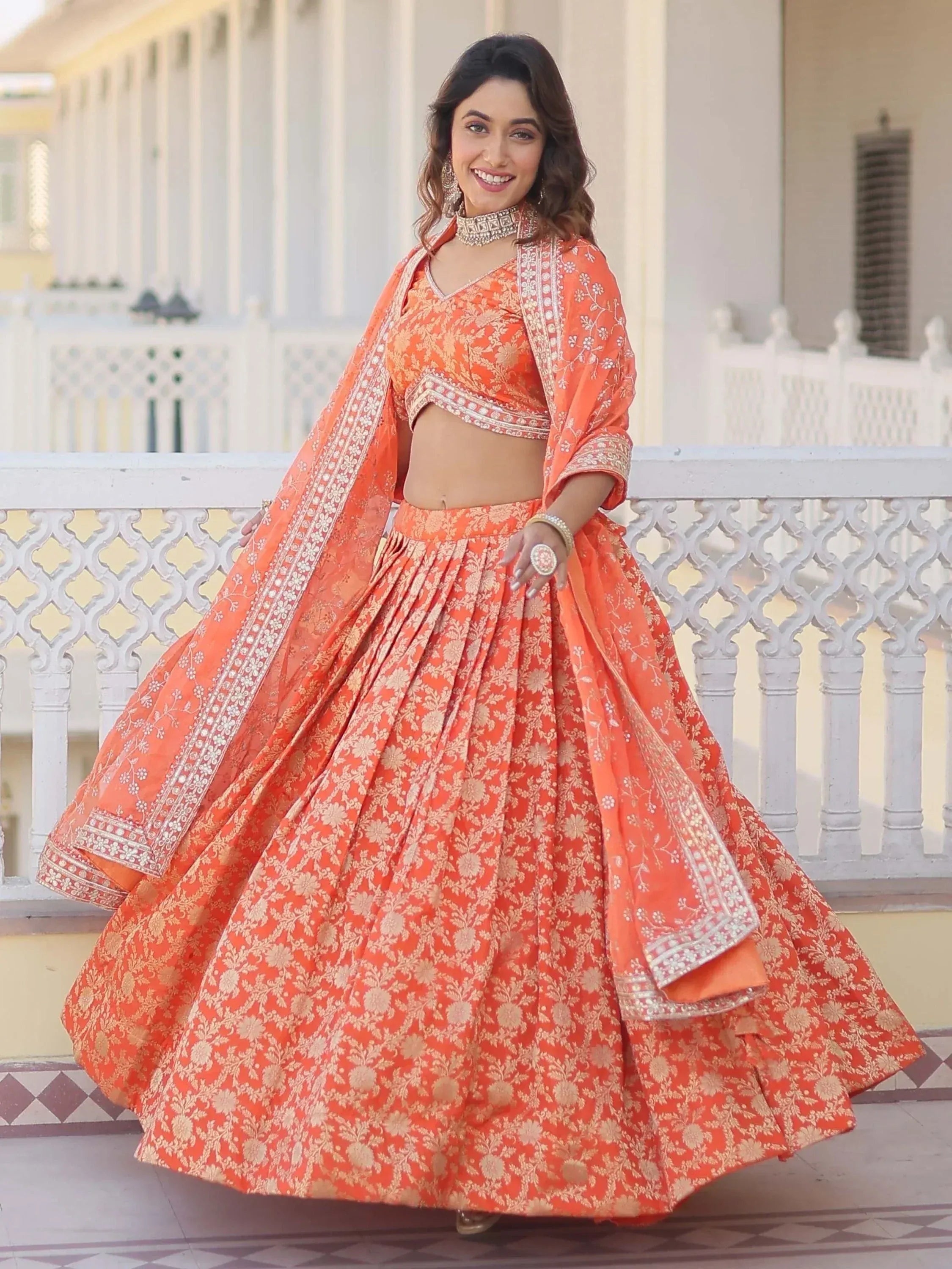 Orange floral lehenga choli with intricate embroidery and matching dupatta for ethnic wear