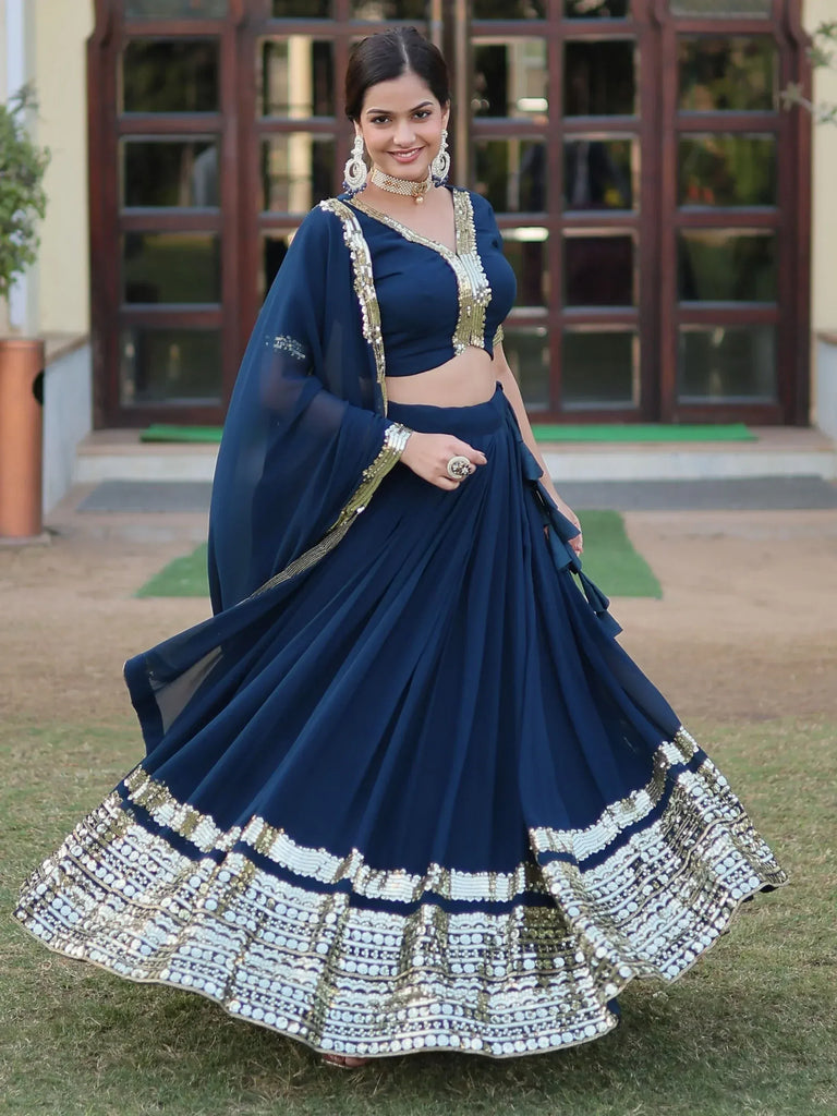 Navy blue designer lehenga choli with gold embroidery, perfect for Indian ethnic wear occasions.