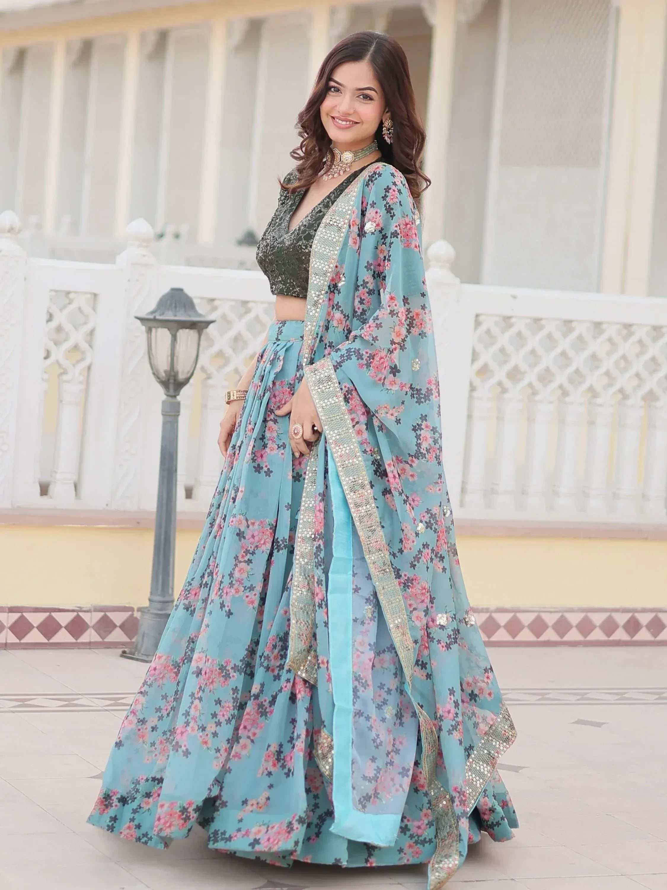 Woman in blue floral lehenga choli with sequin dupatta, Indian ethnic wear for weddings and parties