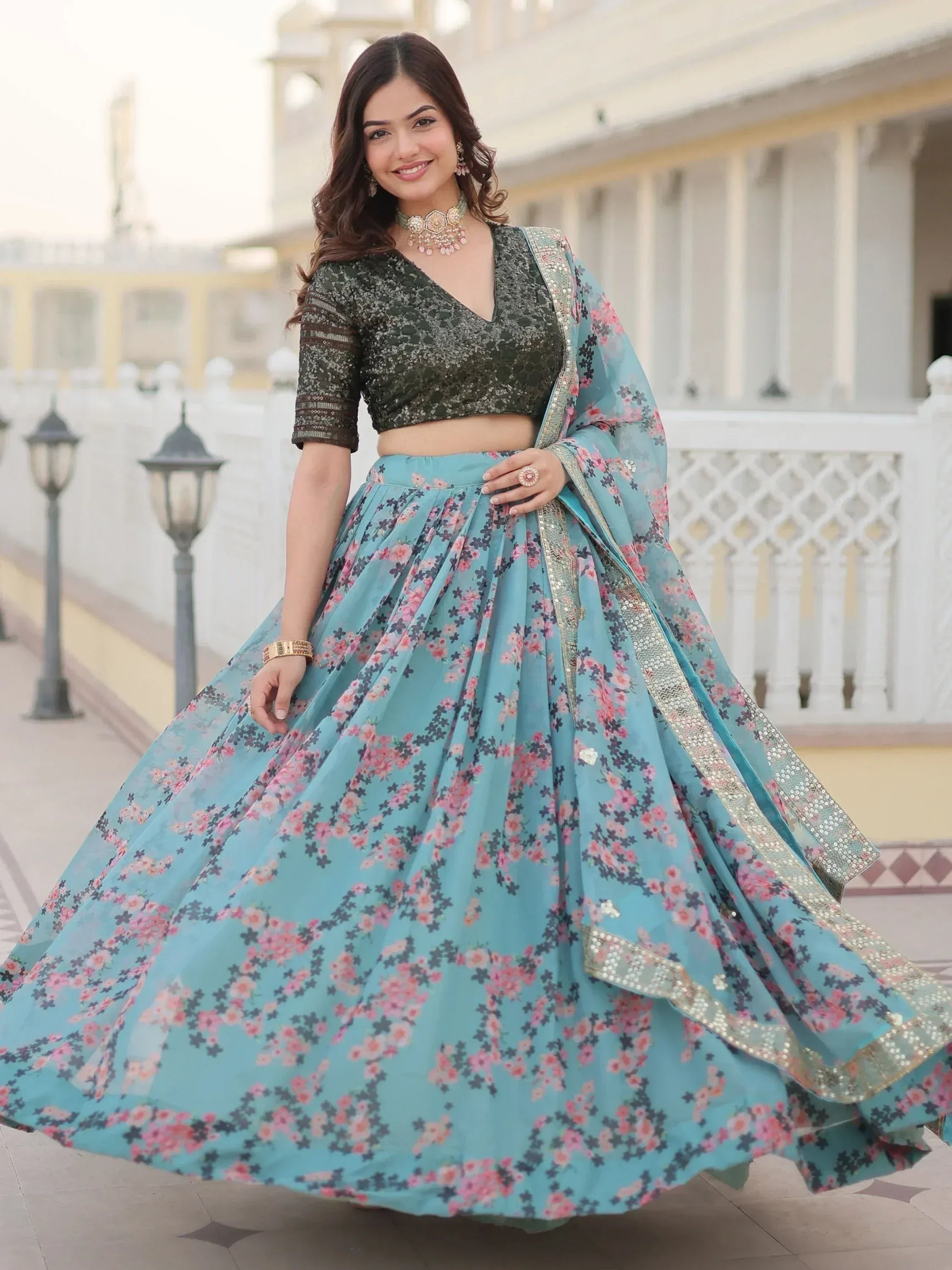 Woman in floral blue lehenga choli with sequin blouse, perfect for Indian ethnic occasions
