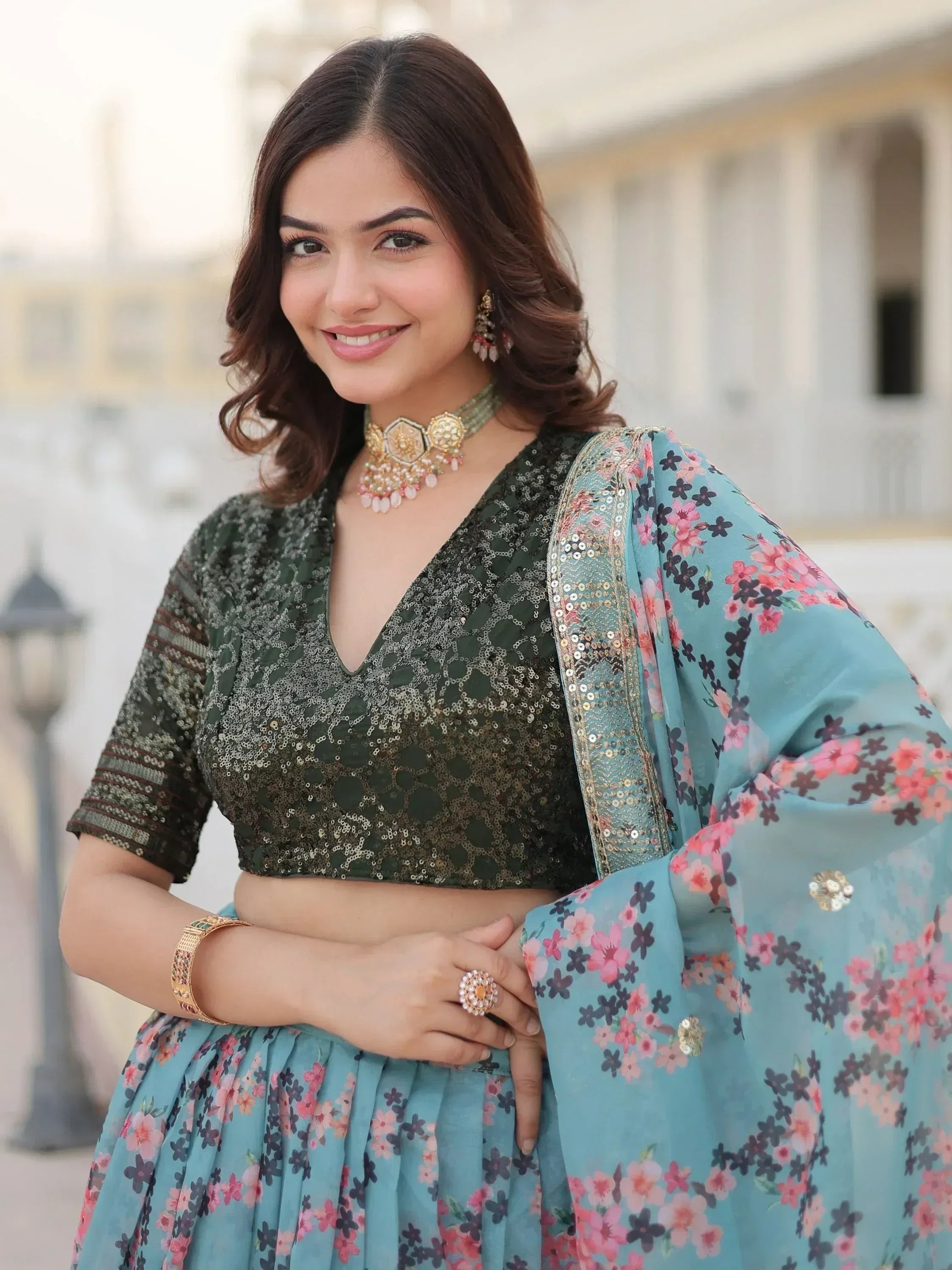 Woman in floral lehenga choli with sequin blouse, perfect for Indian ethnic wear occasions.