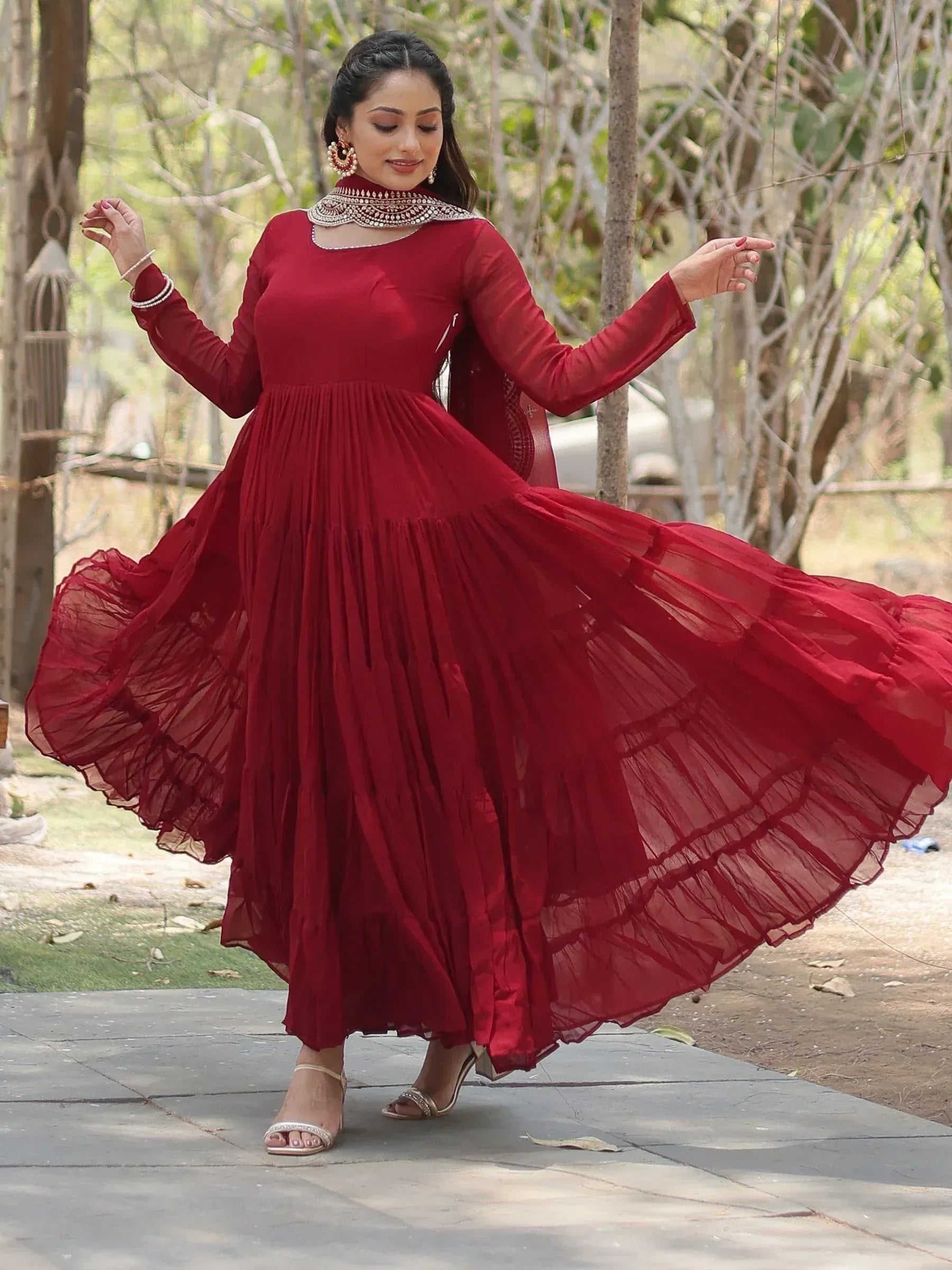 Woman wearing maroon Anarkali dress with dupatta, outdoor ethnic fashion style