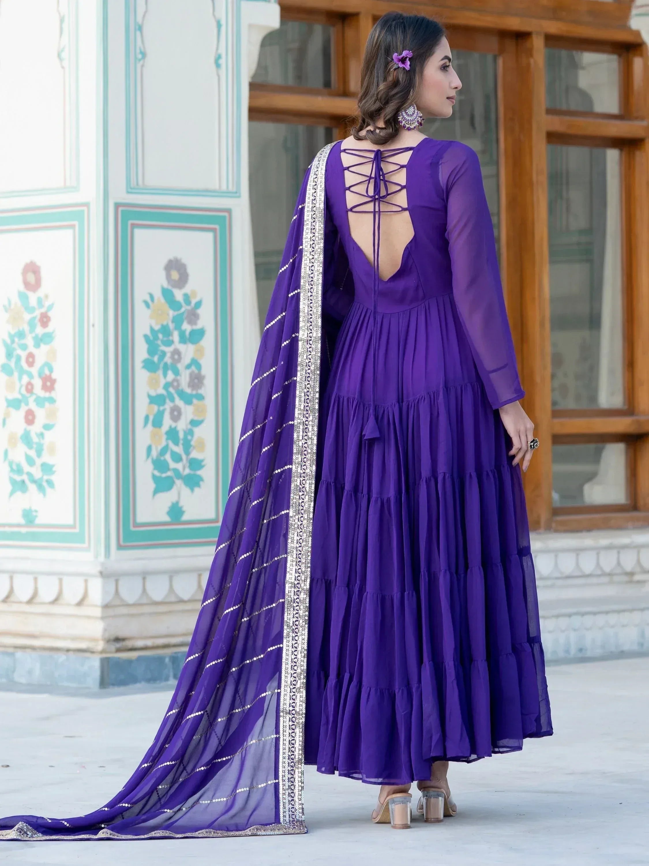 Purple tiered ethnic gown with lace-up back and embellished dupatta, perfect for Indian occasions.