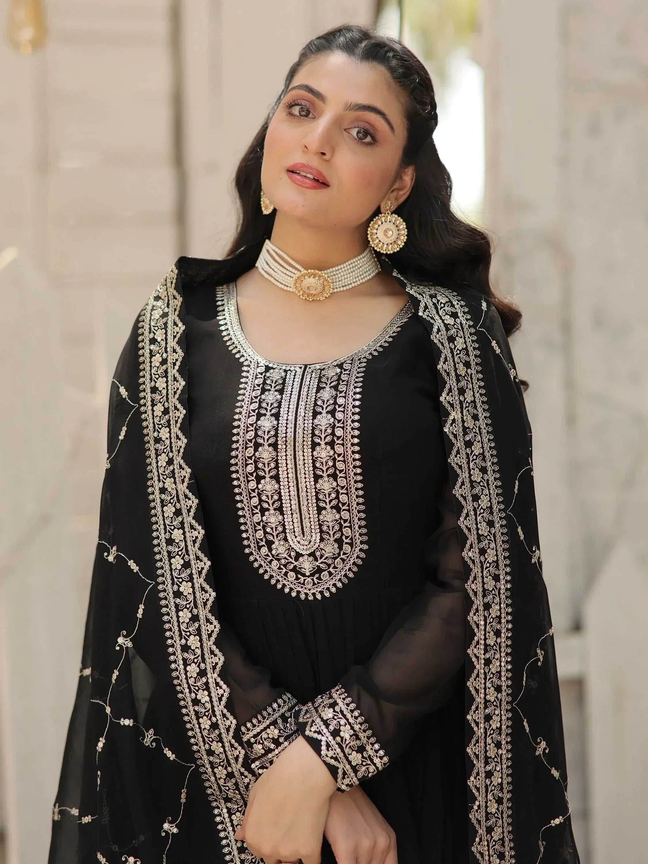 Black embroidered ethnic gown with gold detailing, perfect for Indian festive wear and special occasions.