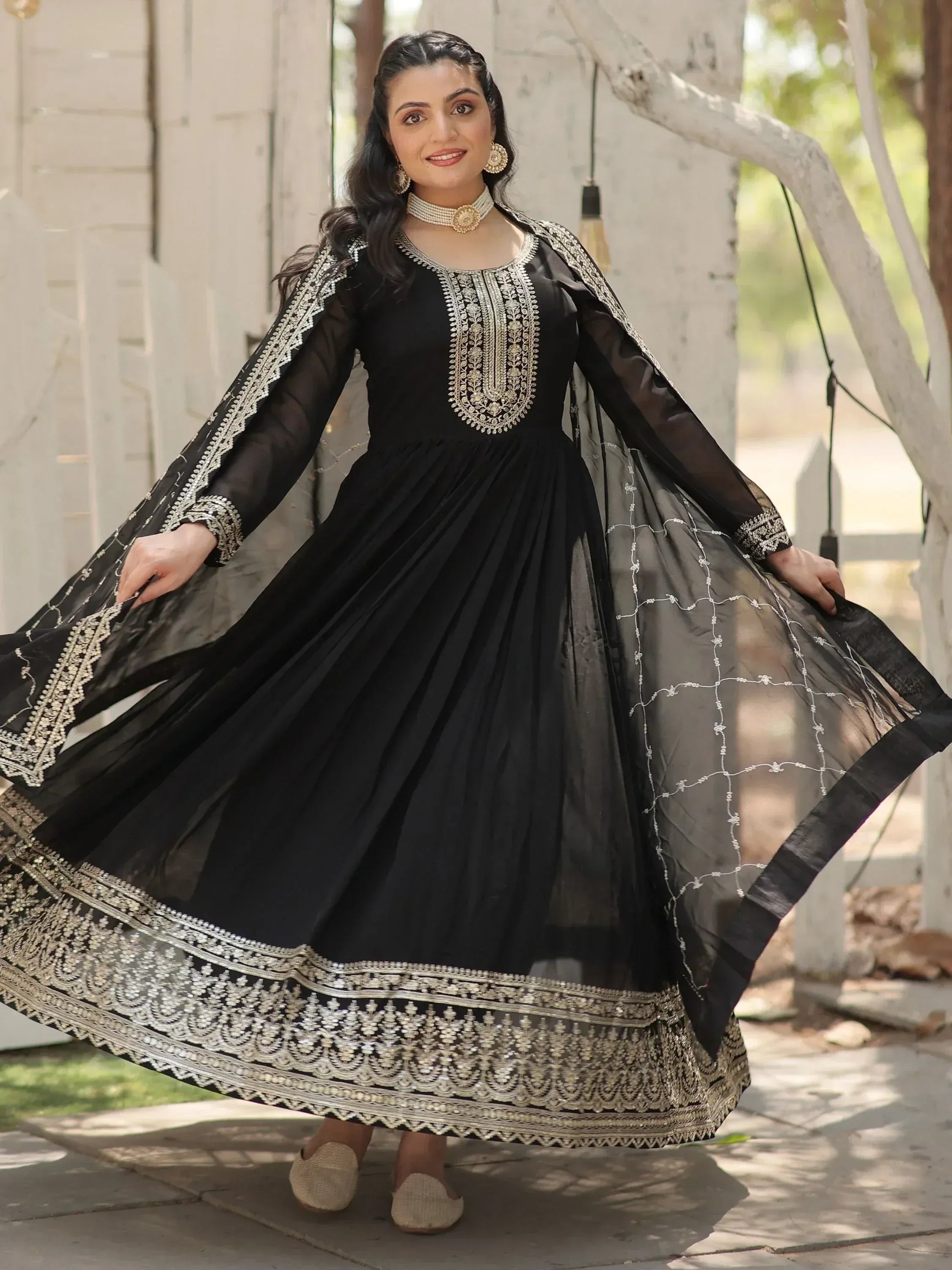 Black ethnic gown with gold embroidery, perfect for Indian occasions and festive wear.