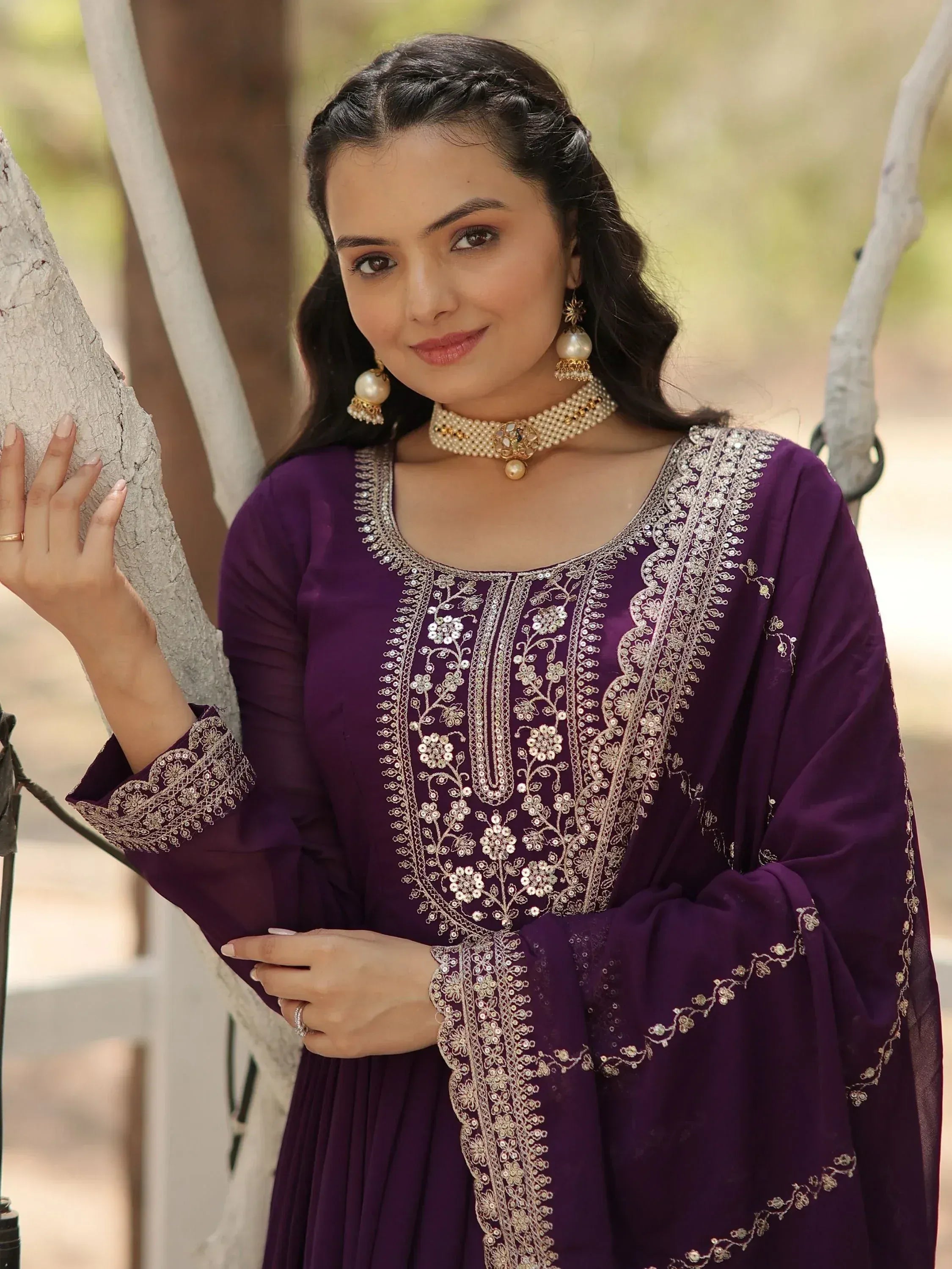 Purple embroidered ethnic gown with gold detailing, perfect for Indian occasions and festive wear.