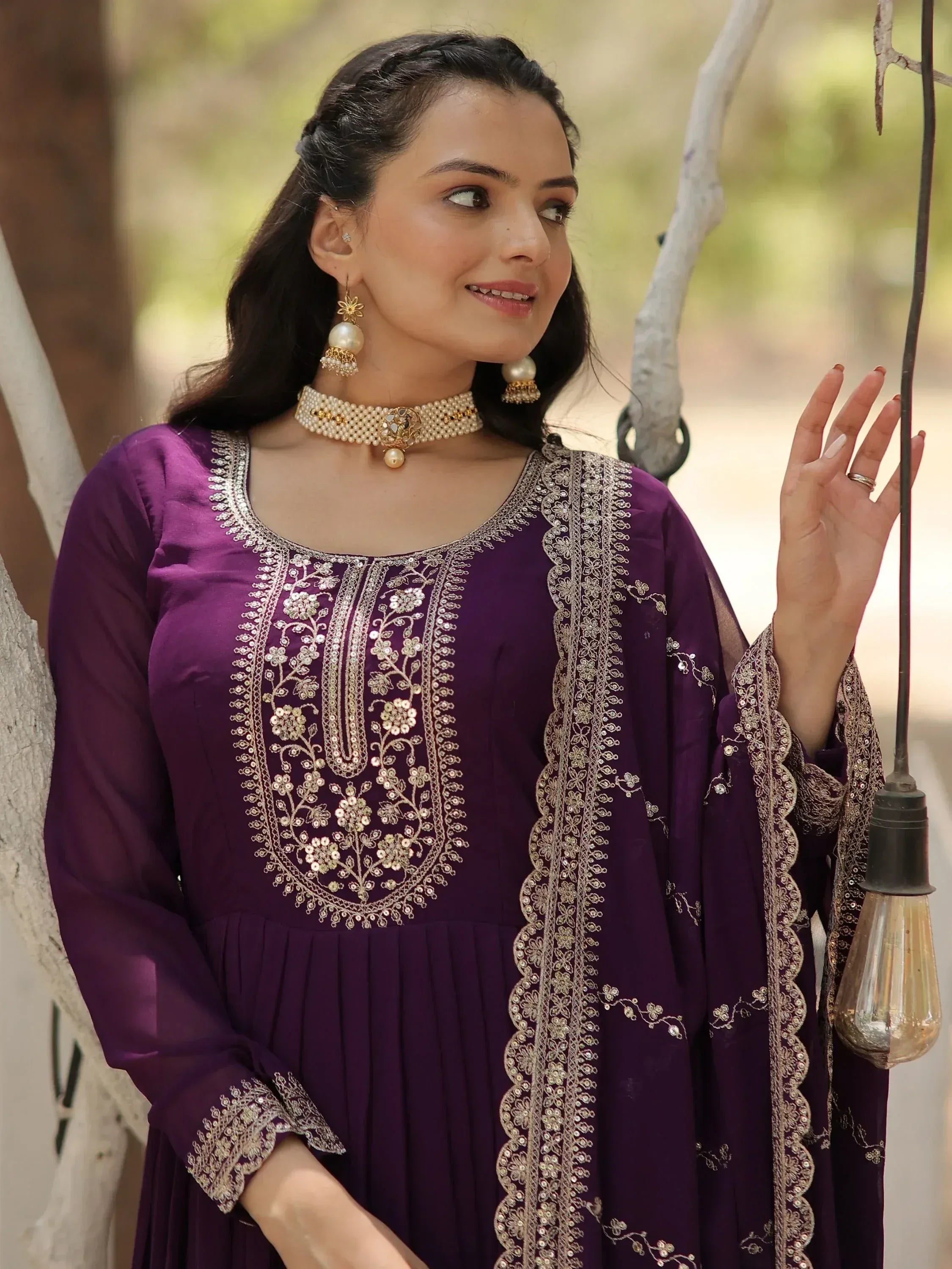 Purple embroidered ethnic gown with gold detailing, perfect for Indian festive wear and designer occasions.