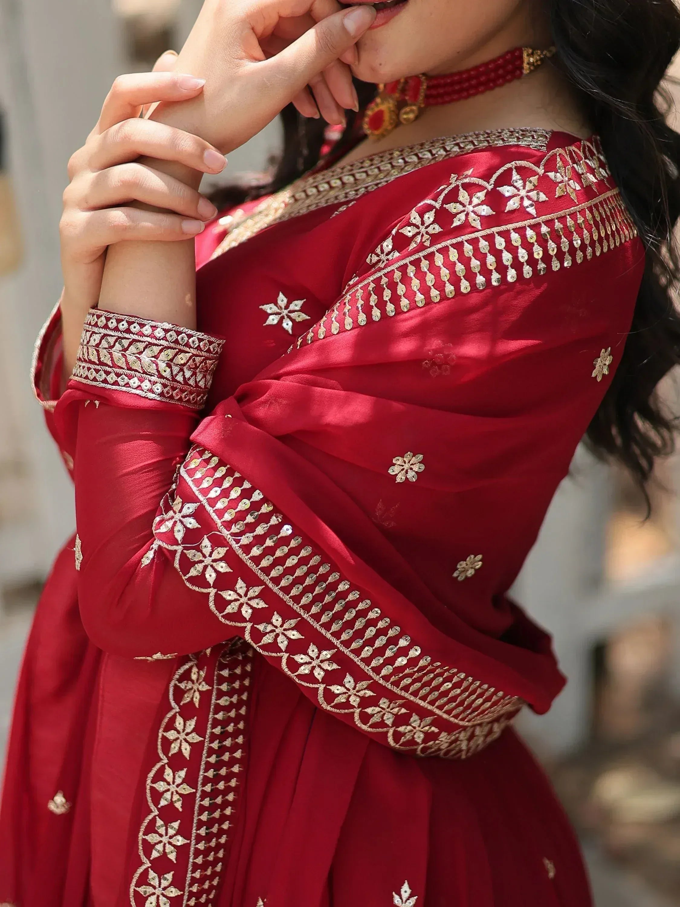 Red ethnic gown with gold embroidery, perfect for Indian weddings and festive occasions.