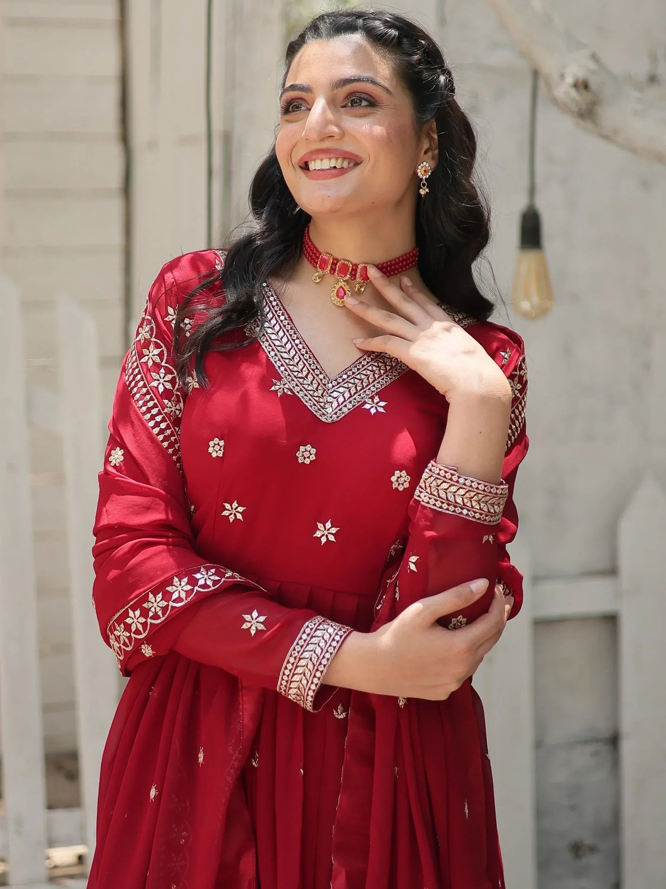 Red embroidered ethnic gown with gold detailing, perfect for Indian festive occasions and weddings.