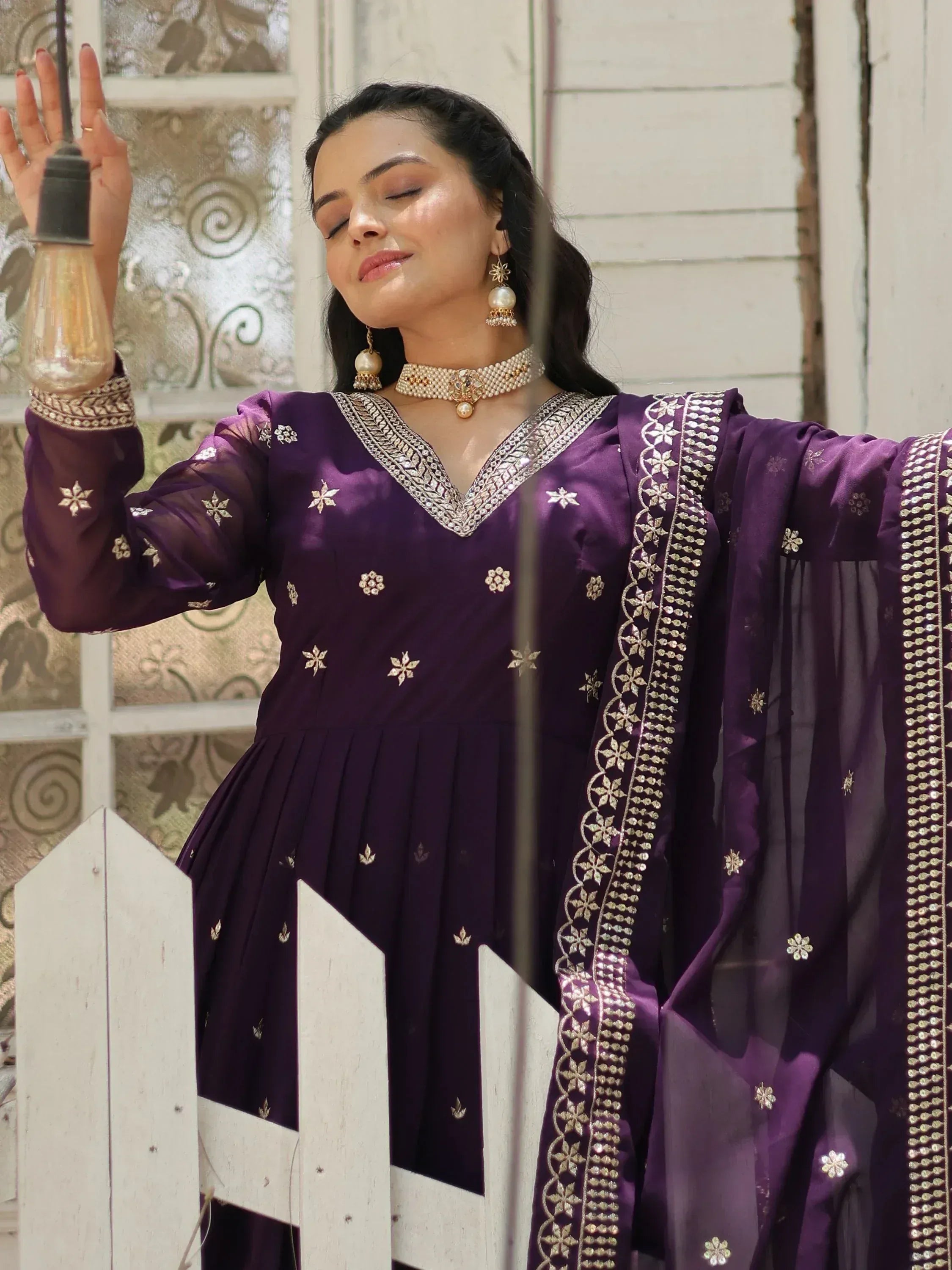 Purple embroidered ethnic gown with gold detailing, perfect for festive occasions
