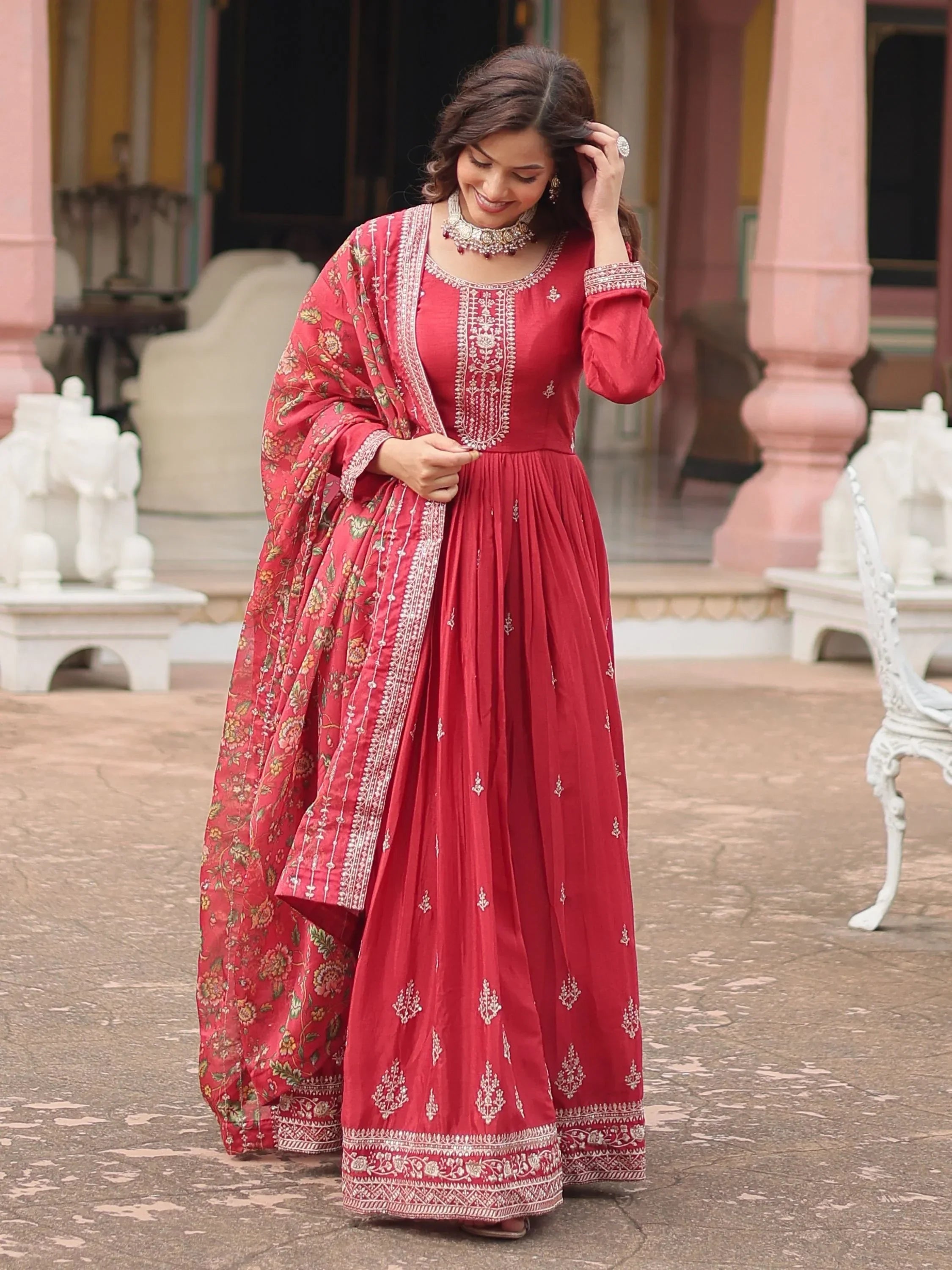 Woman in maroon embroidered anarkali suit with floral dupatta, traditional ethnic wear