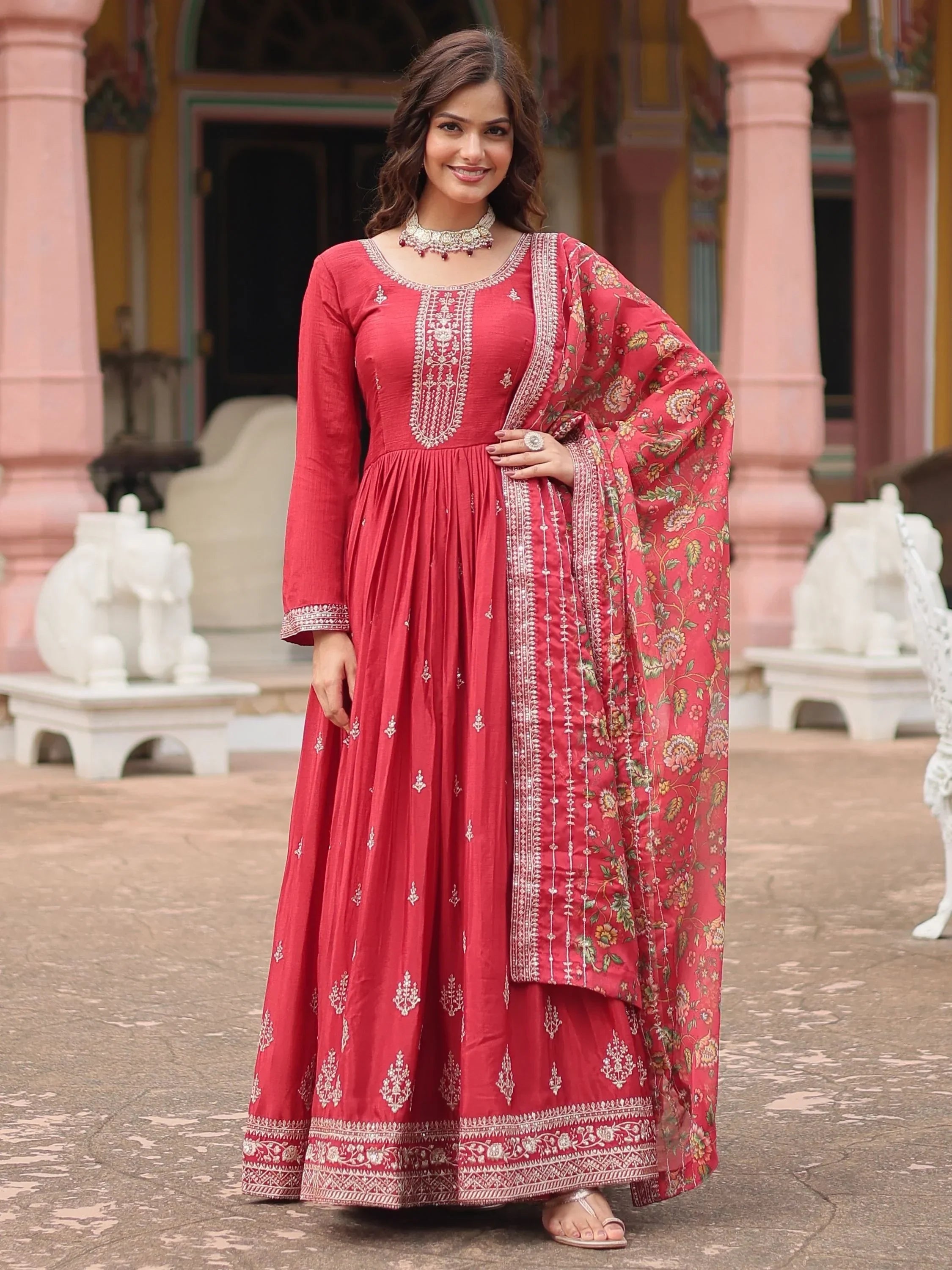Woman in maroon ethnic Anarkali suit with embroidered dupatta and traditional jewelry