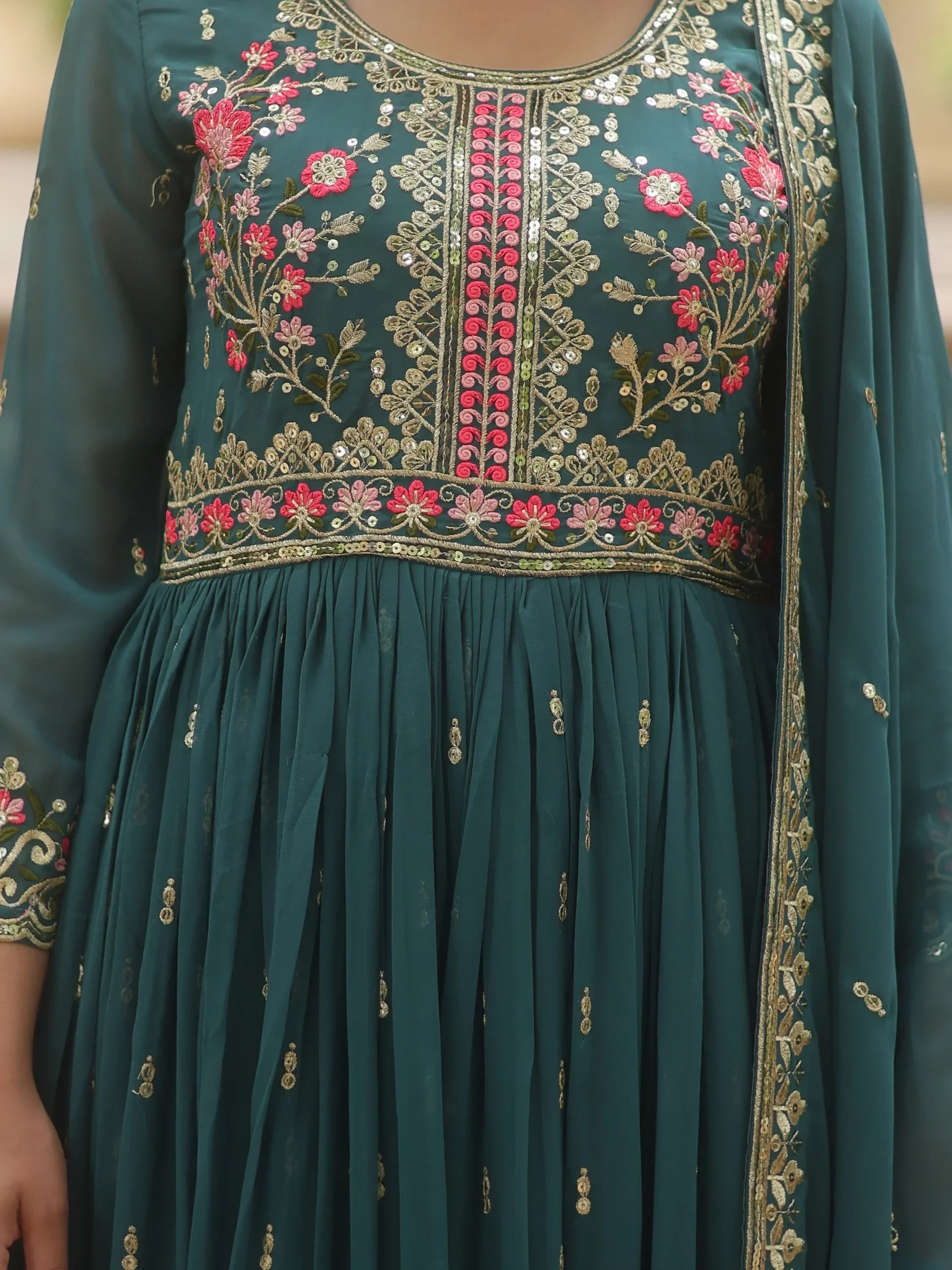 Teal ethnic gown with floral embroidery, gold sequins, and sheer long sleeves