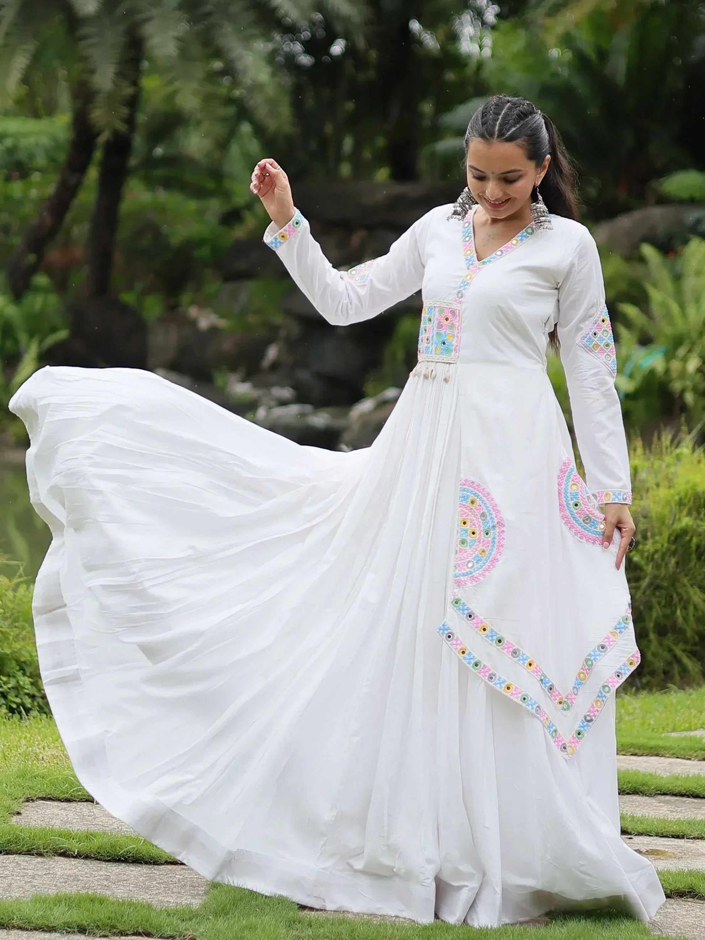 White ethnic gown with colorful mirror work, perfect for Indian occasions and festive wear.