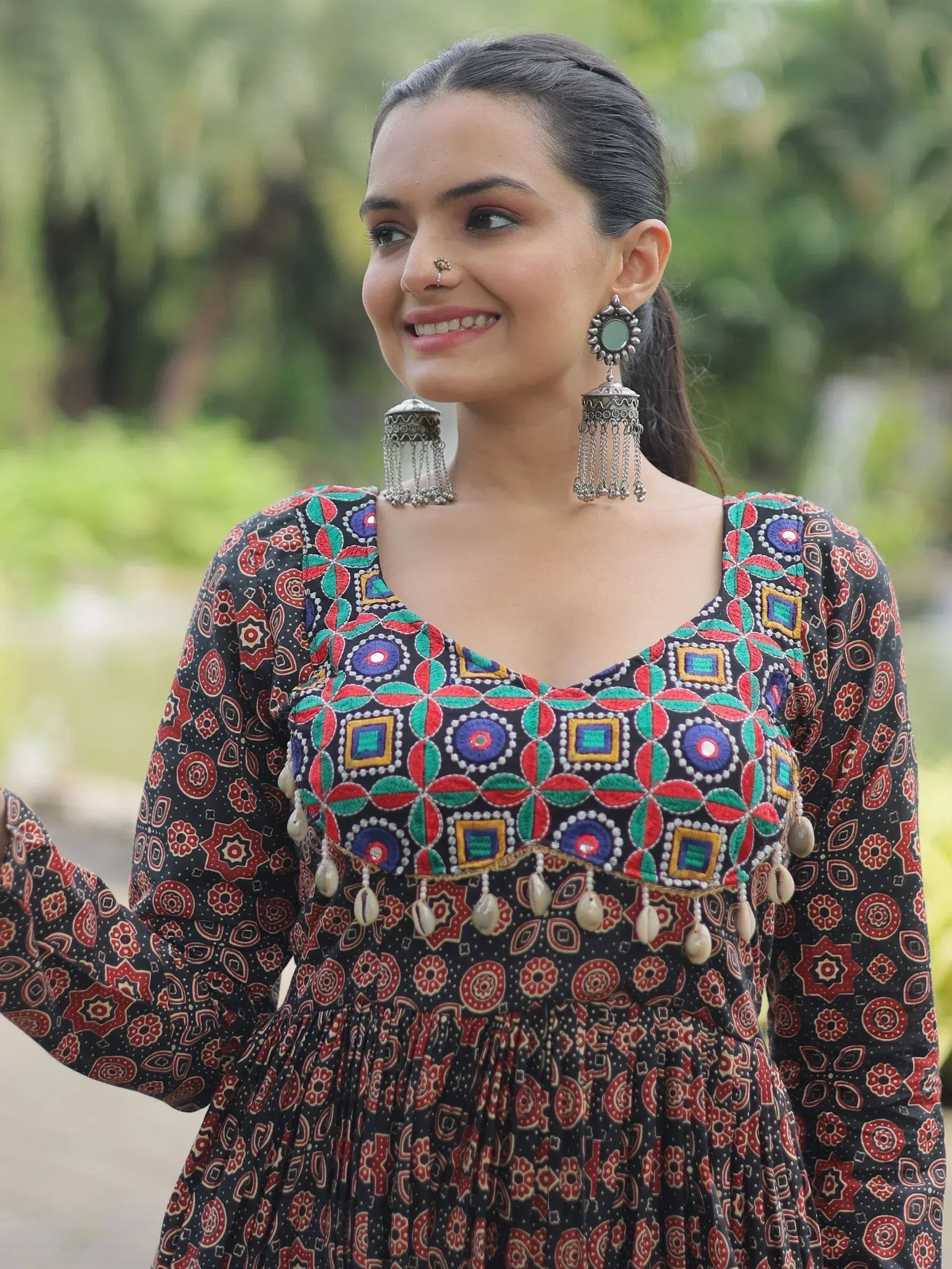 Woman in colorful embroidered ethnic dress with traditional jewelry and nose ring