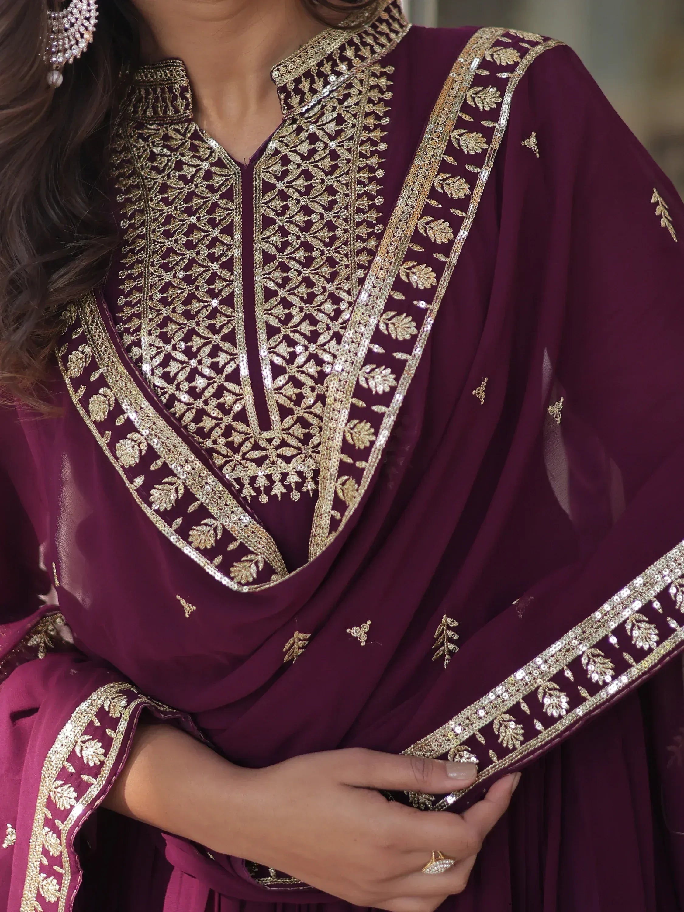 Elegant maroon ethnic wear with gold embroidery and sequin detailing, perfect for festive occasions.