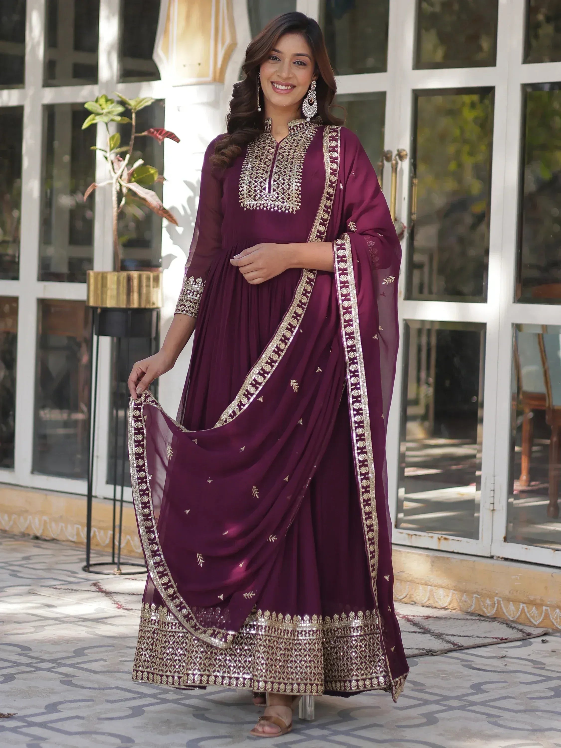 Elegant maroon ethnic gown with gold embroidery and matching dupatta for festive occasions
