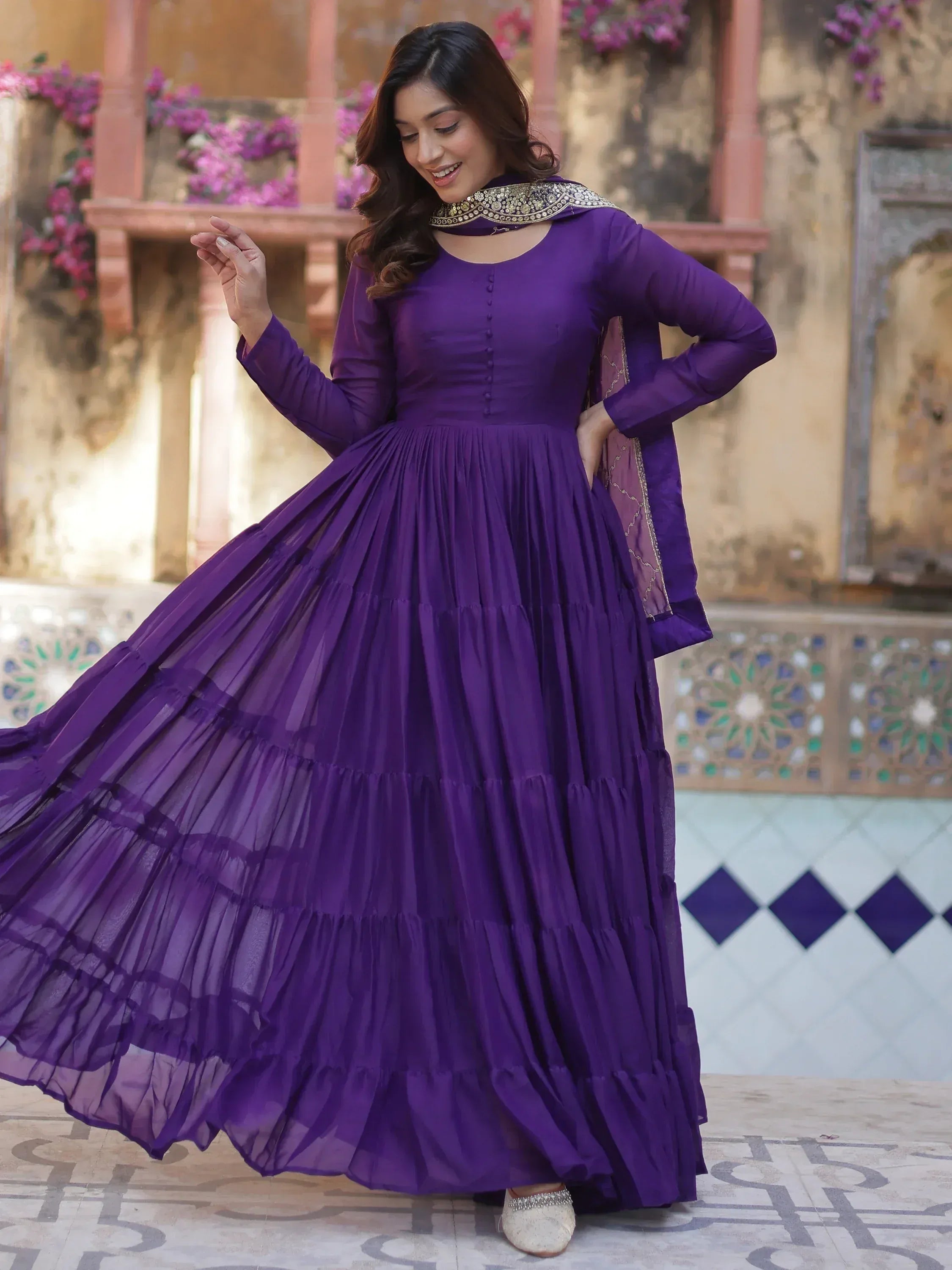 Purple ethnic gown with tiered skirt and embroidered neckline, perfect for Indian festive occasions