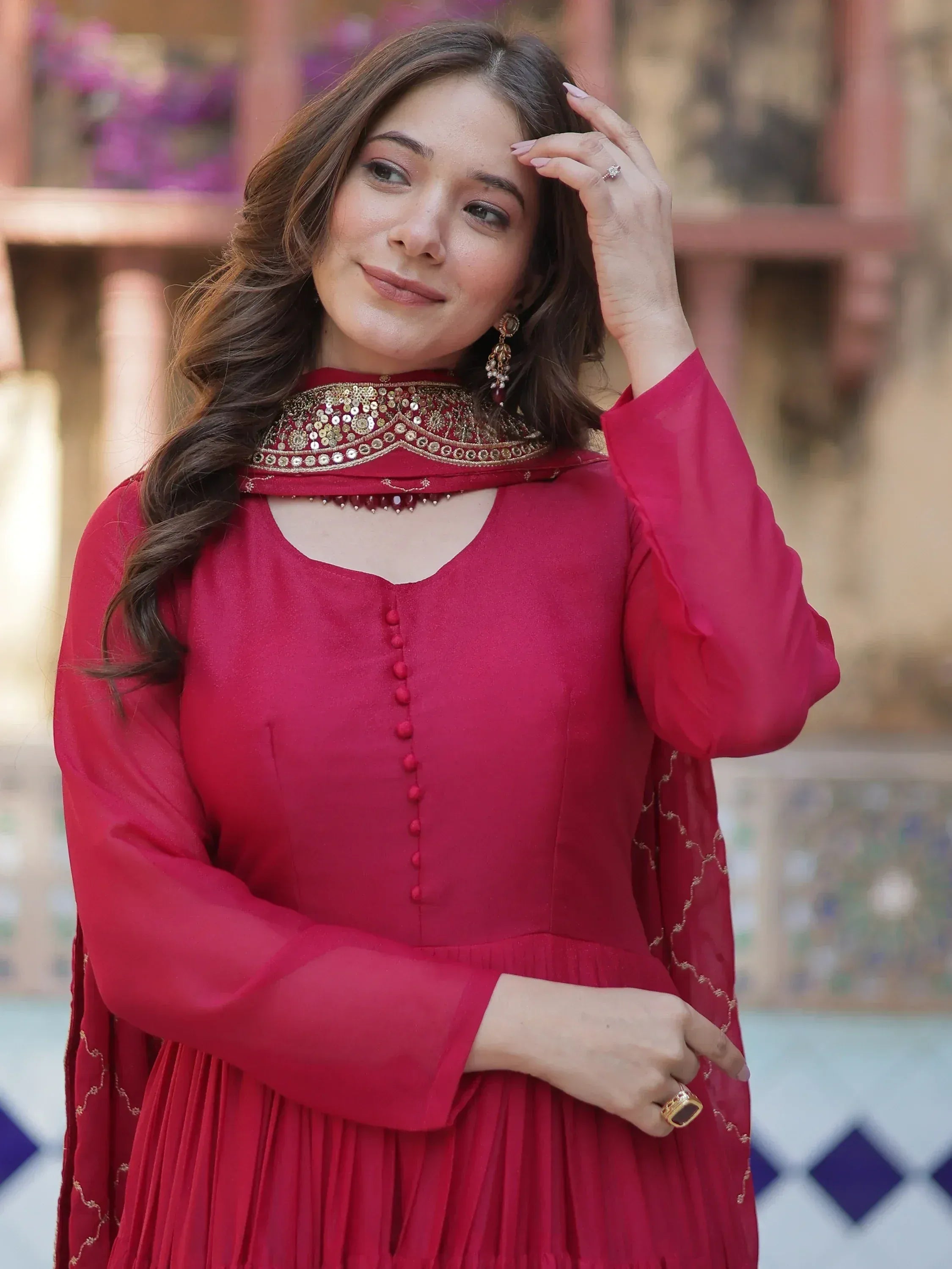 Woman in red ethnic gown with gold embroidery, perfect for Indian festive occasions and weddings