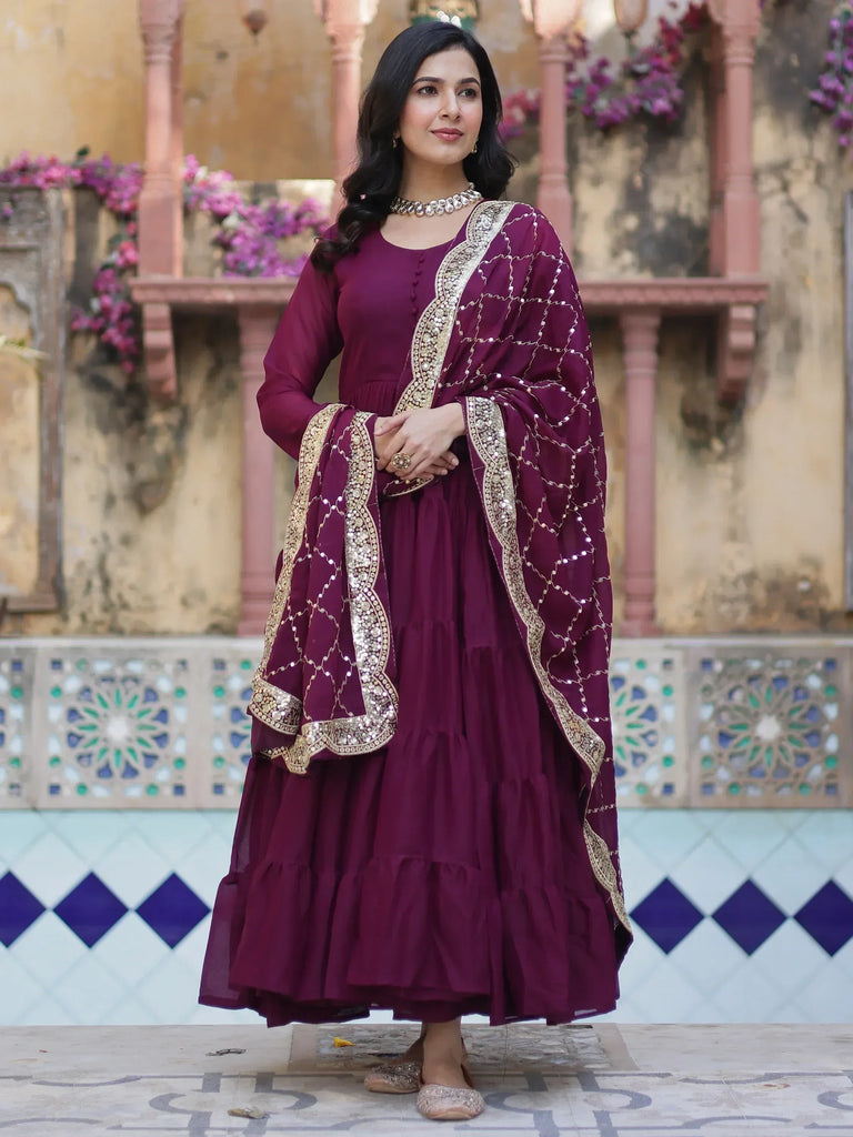 Elegant maroon Indian ethnic gown with gold embroidery, perfect for festive occasions and weddings.