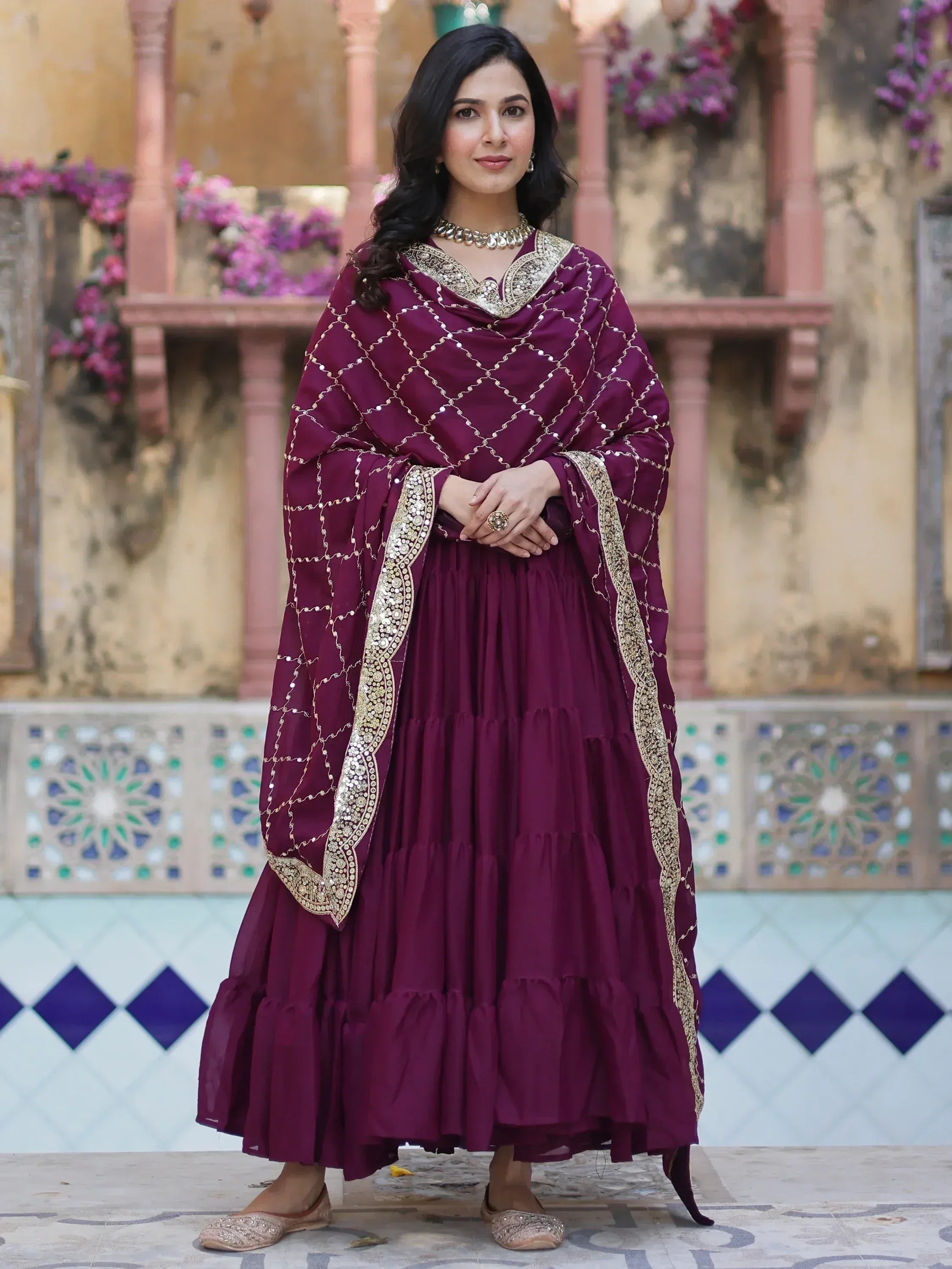 Elegant maroon ethnic gown with gold embroidery and dupatta, perfect for Indian occasions