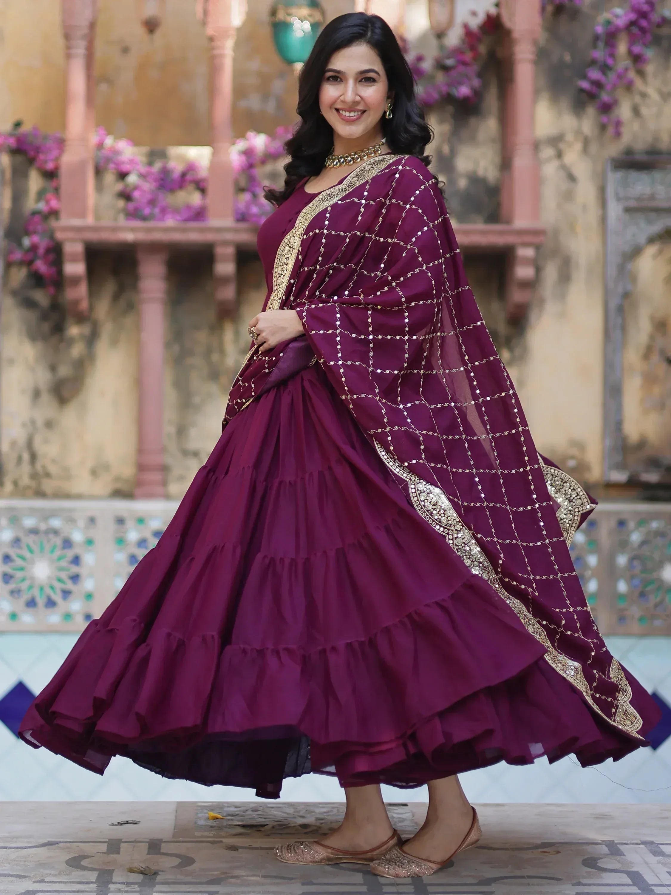 Woman in maroon designer lehenga choli with gold embroidery, perfect for Indian ethnic wear occasions