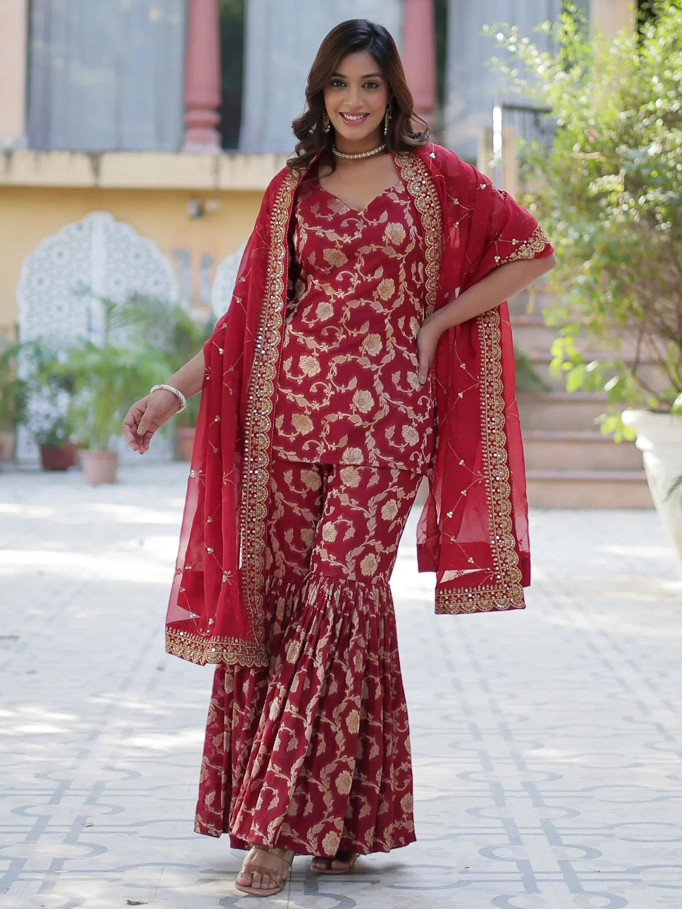 Red floral ethnic salwar kameez with gold embroidery and dupatta, perfect for festive occasions.