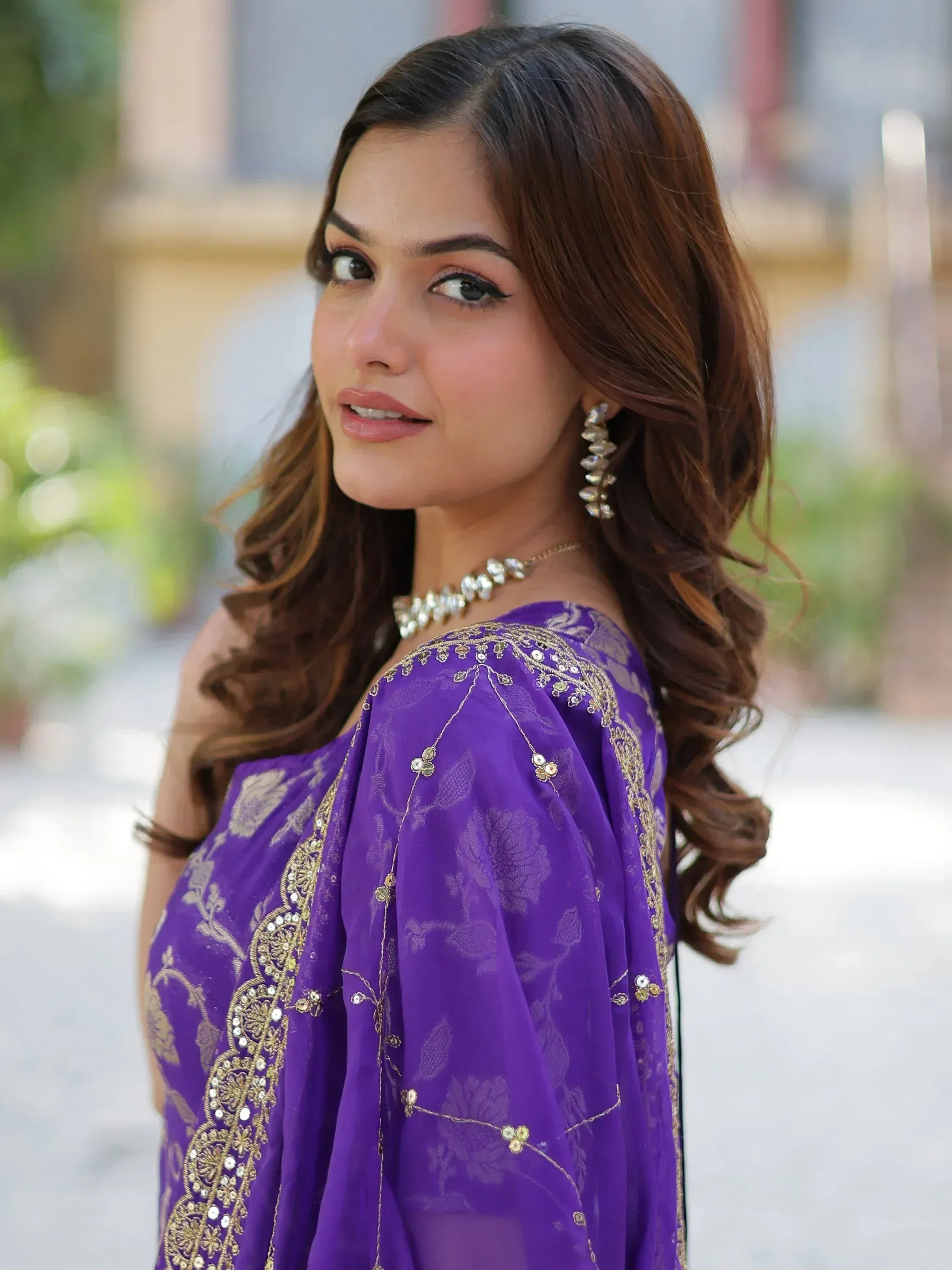 Purple embroidered ethnic gown with gold detailing and floral patterns
