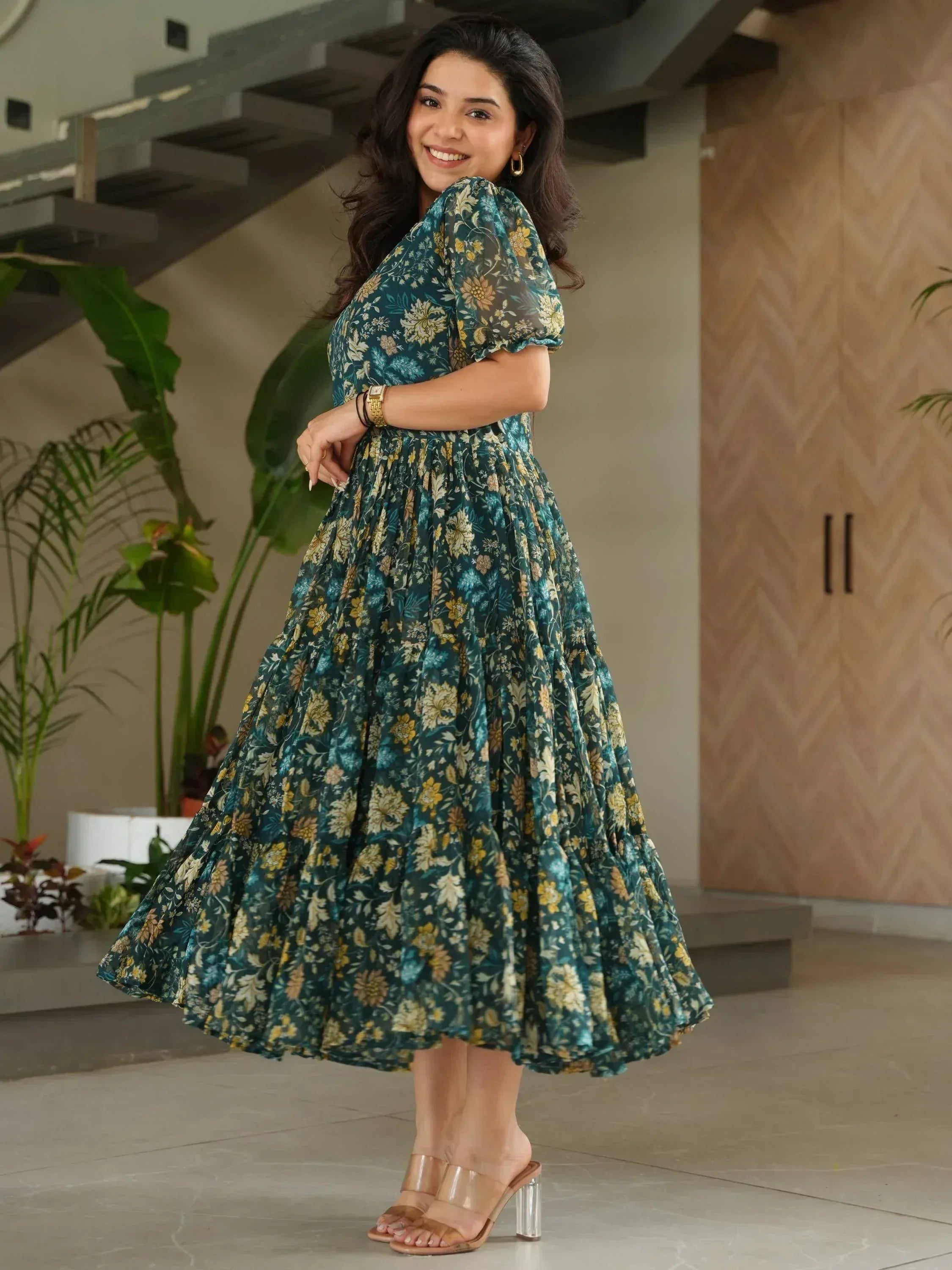 Elegant teal floral ethnic gown with puff sleeves and tiered skirt, perfect for festive occasions.