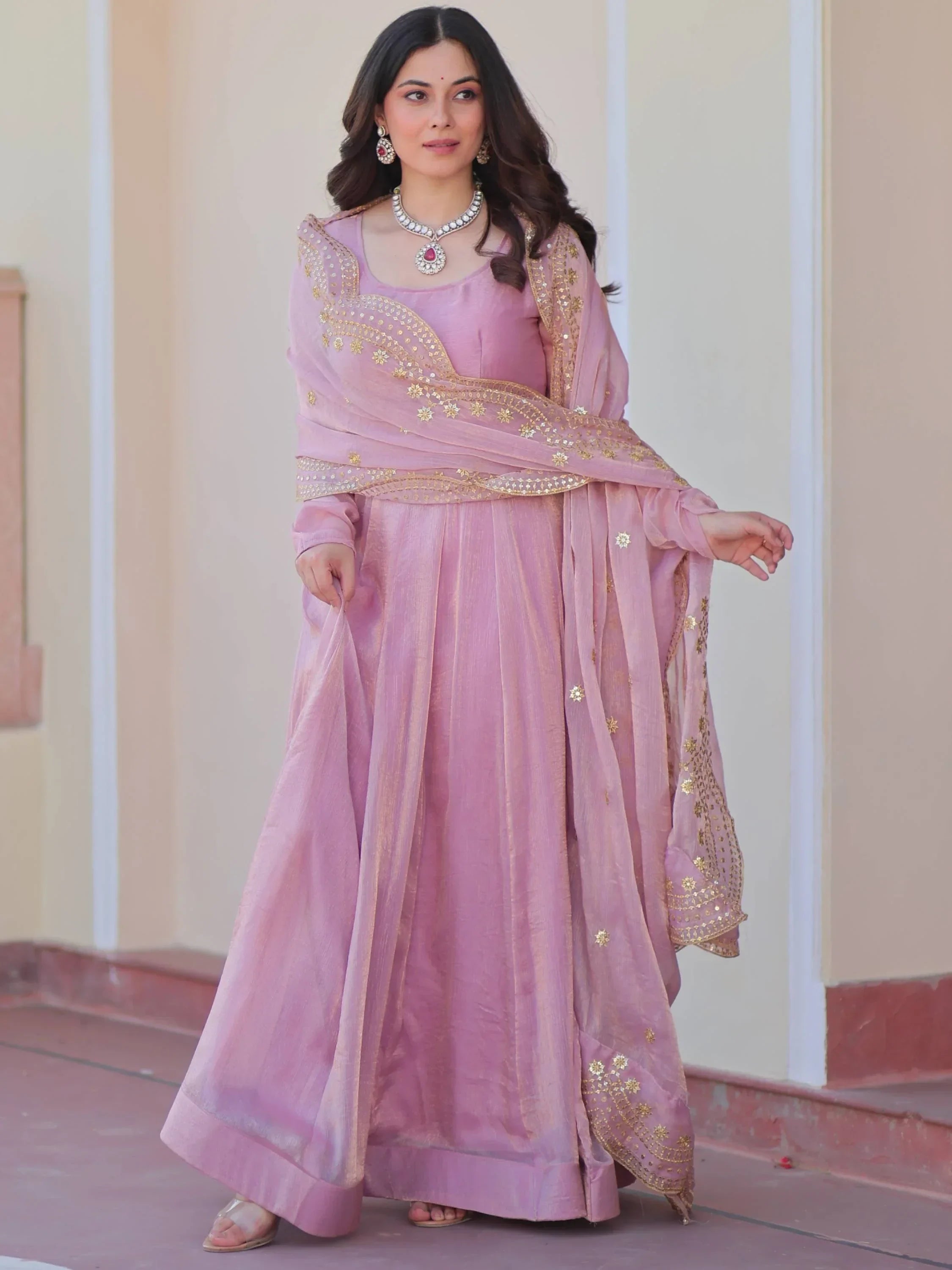 Woman wearing pink ethnic gown with golden embroidered dupatta, Indian traditional fashion