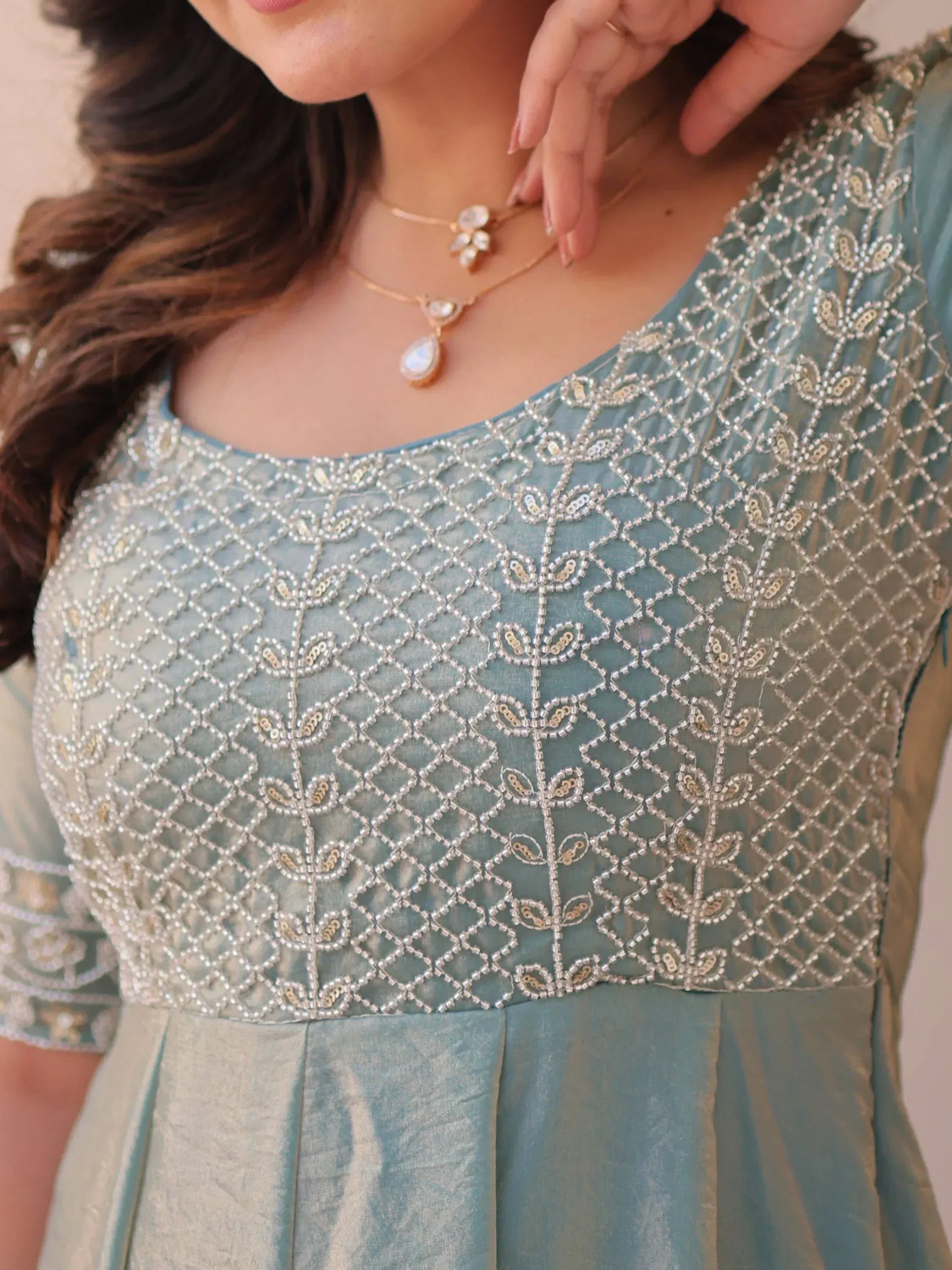 Light blue ethnic gown with intricate silver beadwork and floral embroidery, perfect for Indian occasions.