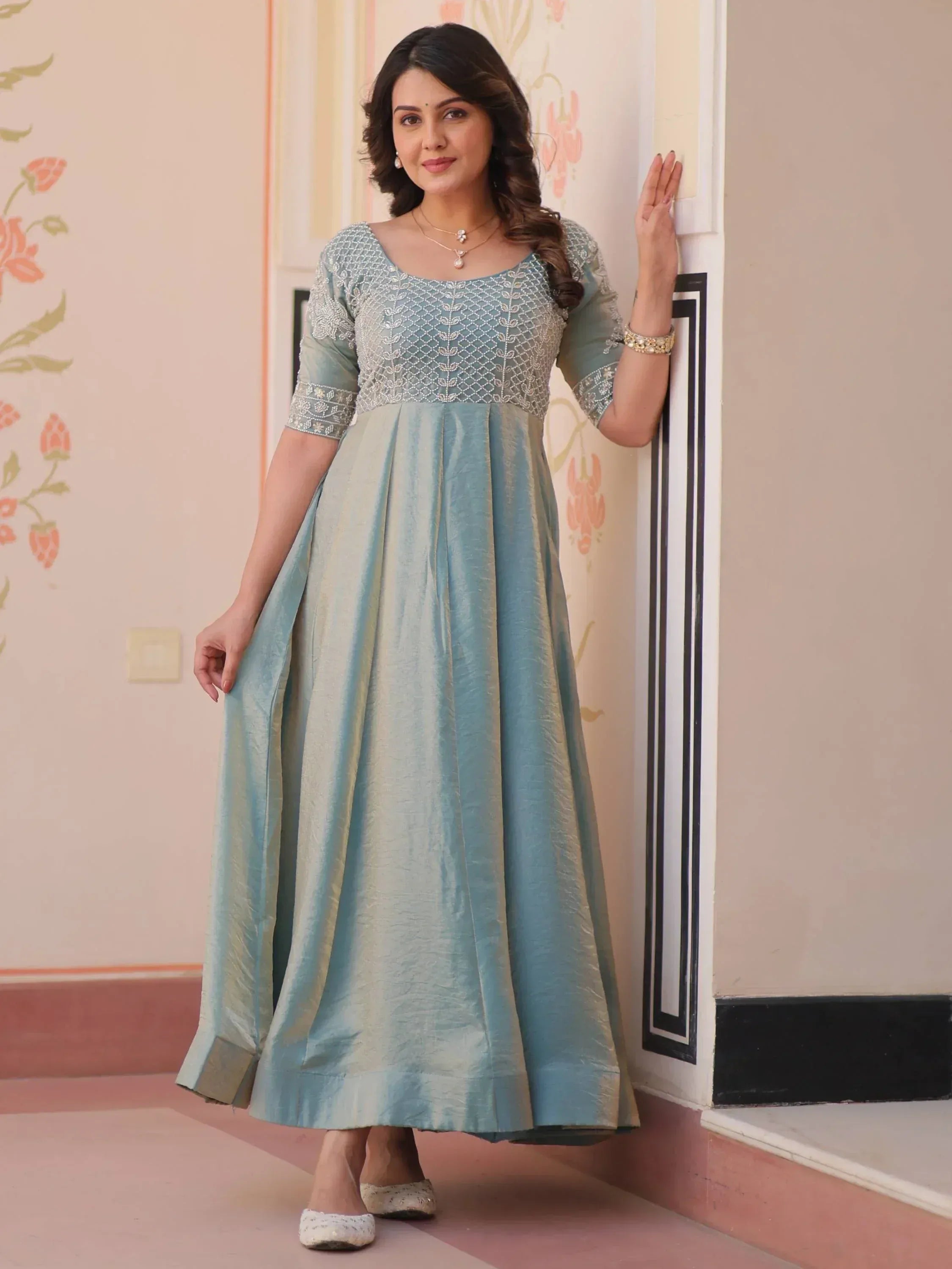 Elegant light blue ethnic gown with silver embroidery, perfect for Indian occasions and festive wear.