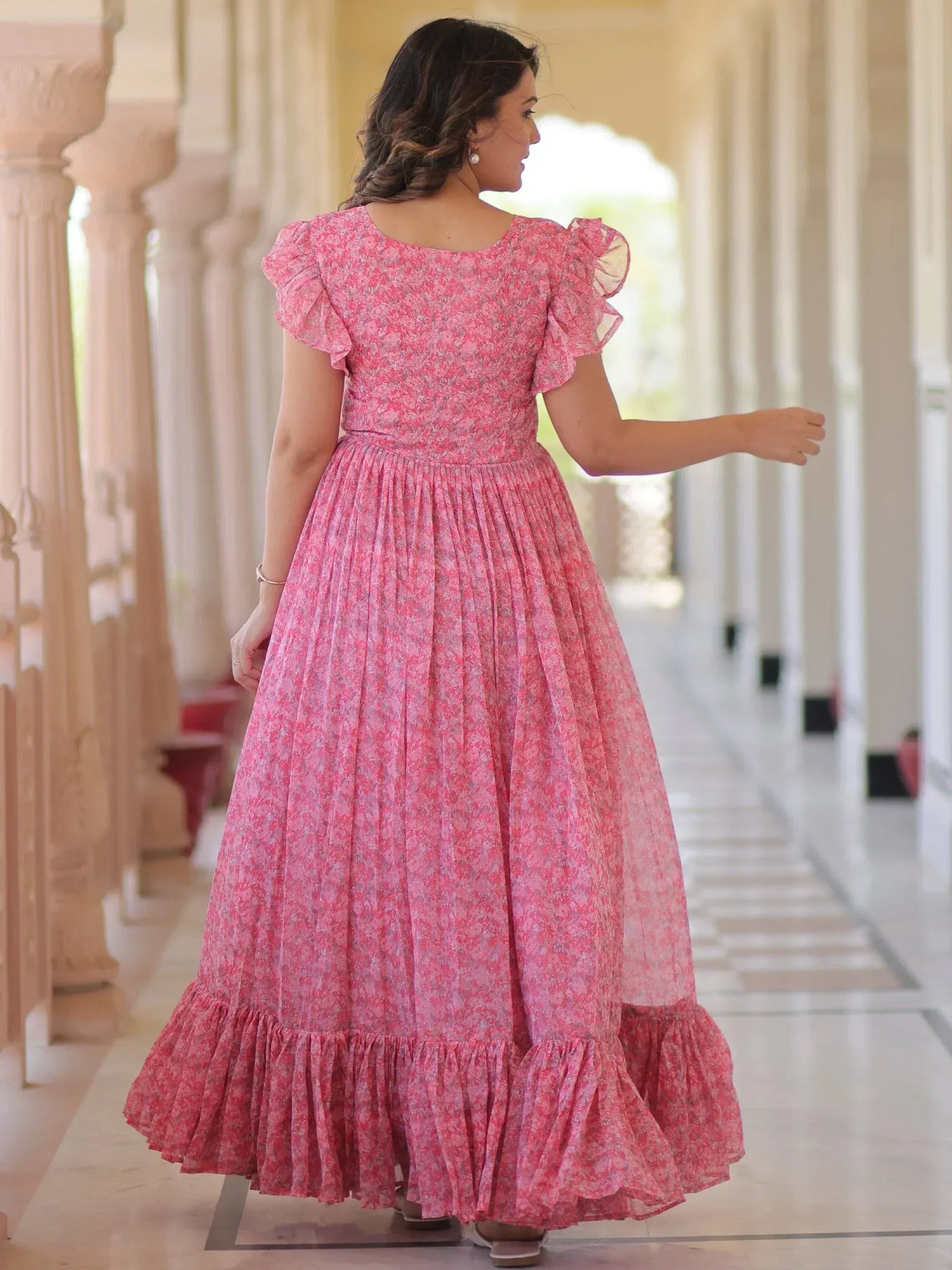 Pink floral ethnic gown with ruffle sleeves and pleated skirt, perfect for Indian occasions