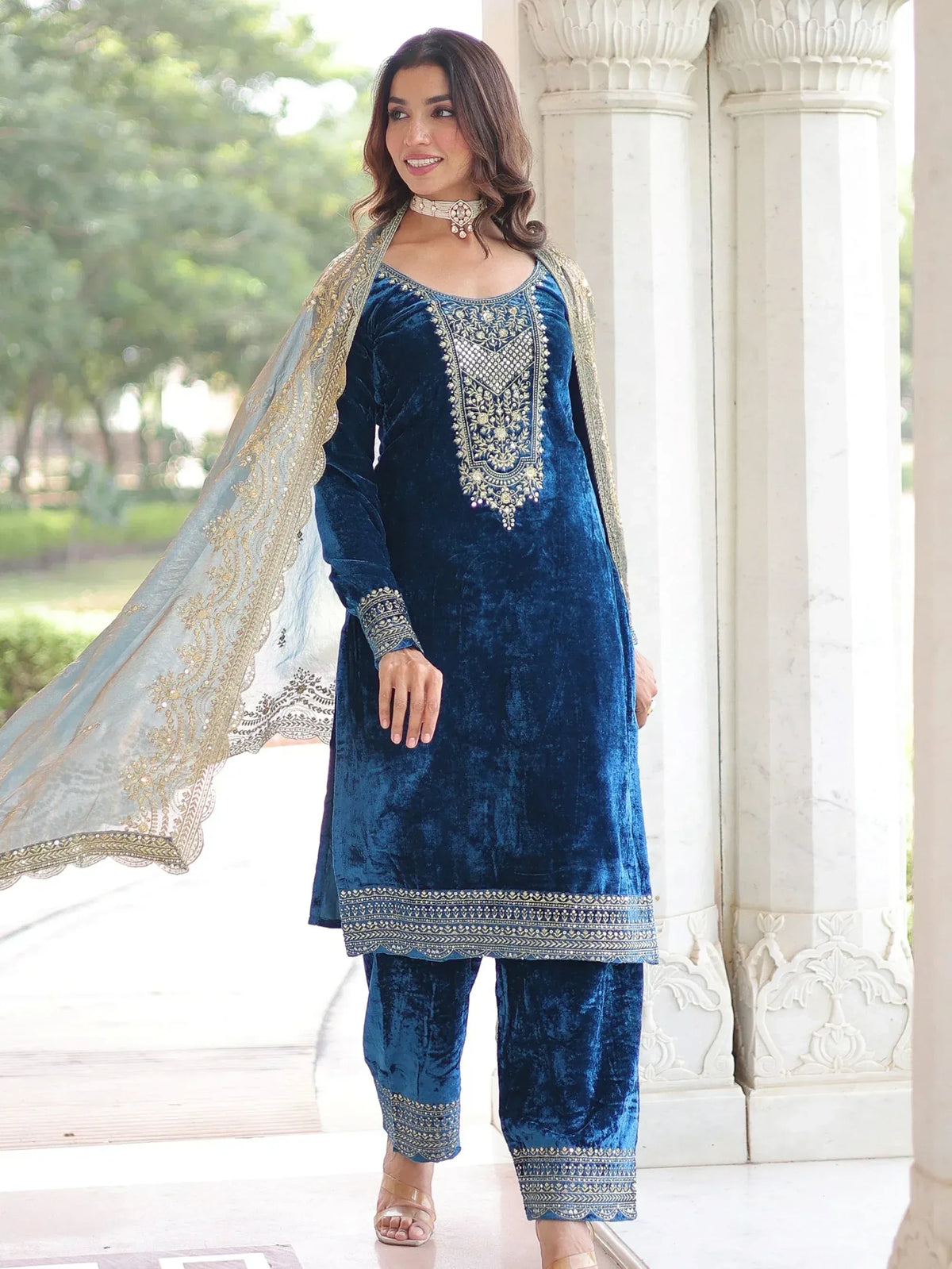 Blue velvet salwar kameez with gold embroidery and matching dupatta, perfect for ethnic occasions.