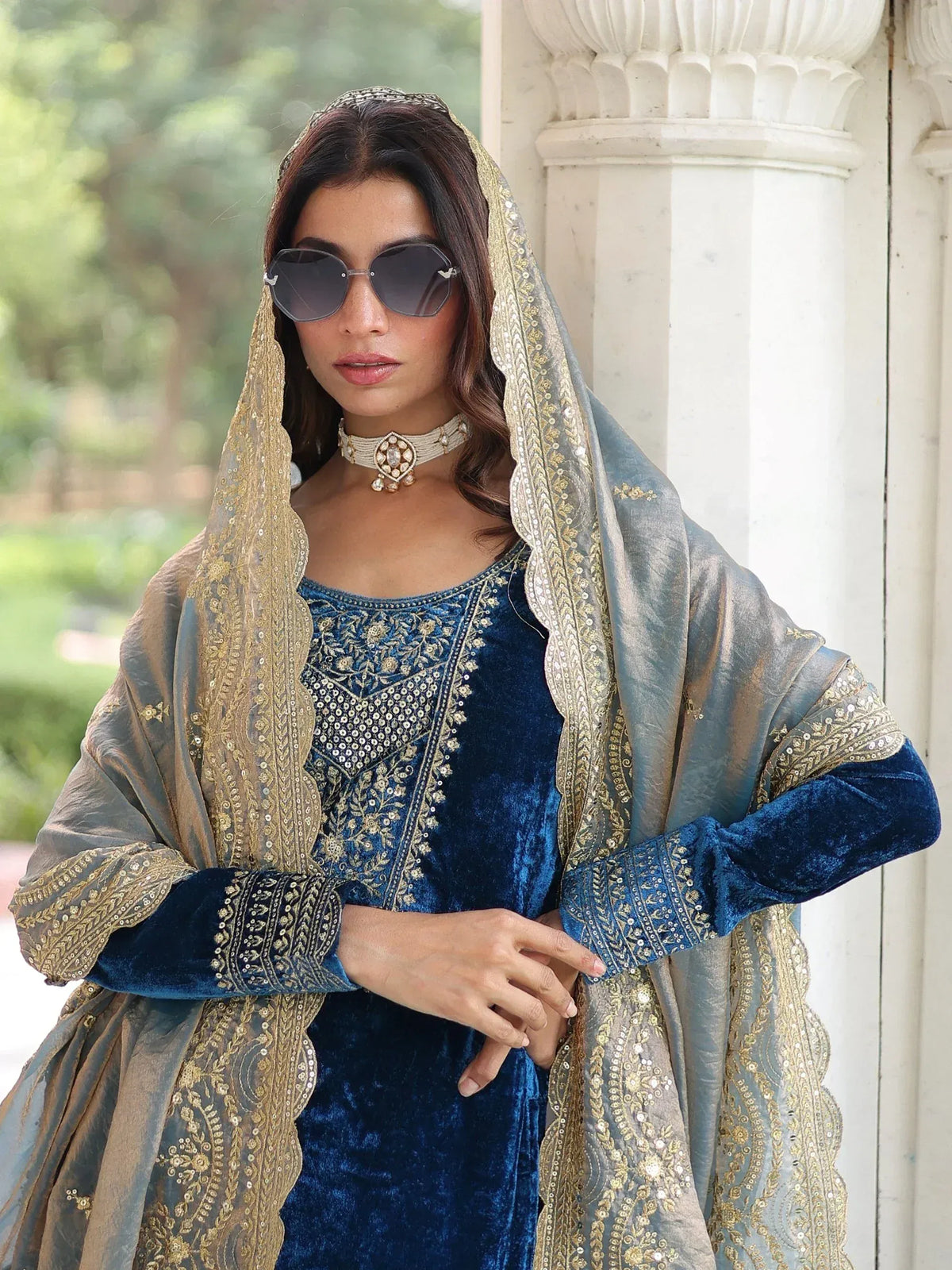 Elegant blue velvet salwar kameez with gold embroidery and matching dupatta, perfect for ethnic occasions.