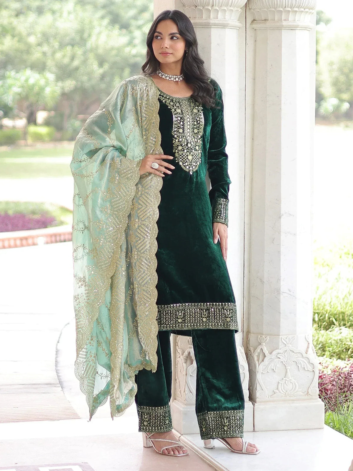 Emerald green velvet salwar kameez with gold embroidery and mint dupatta, perfect for ethnic occasions.