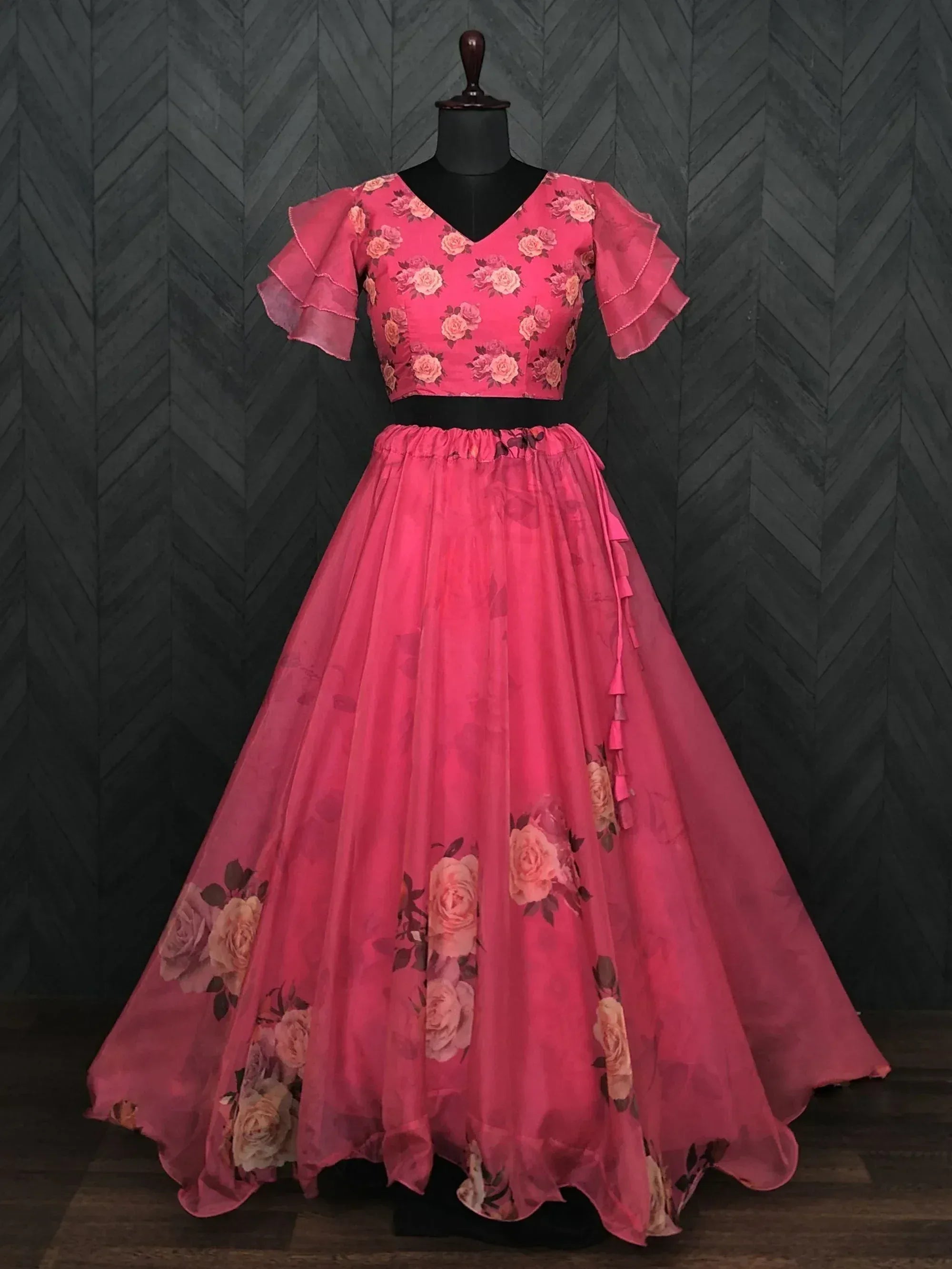 Pink floral lehenga choli with ruffled sleeves and layered skirt, perfect for Indian ethnic wear occasions.