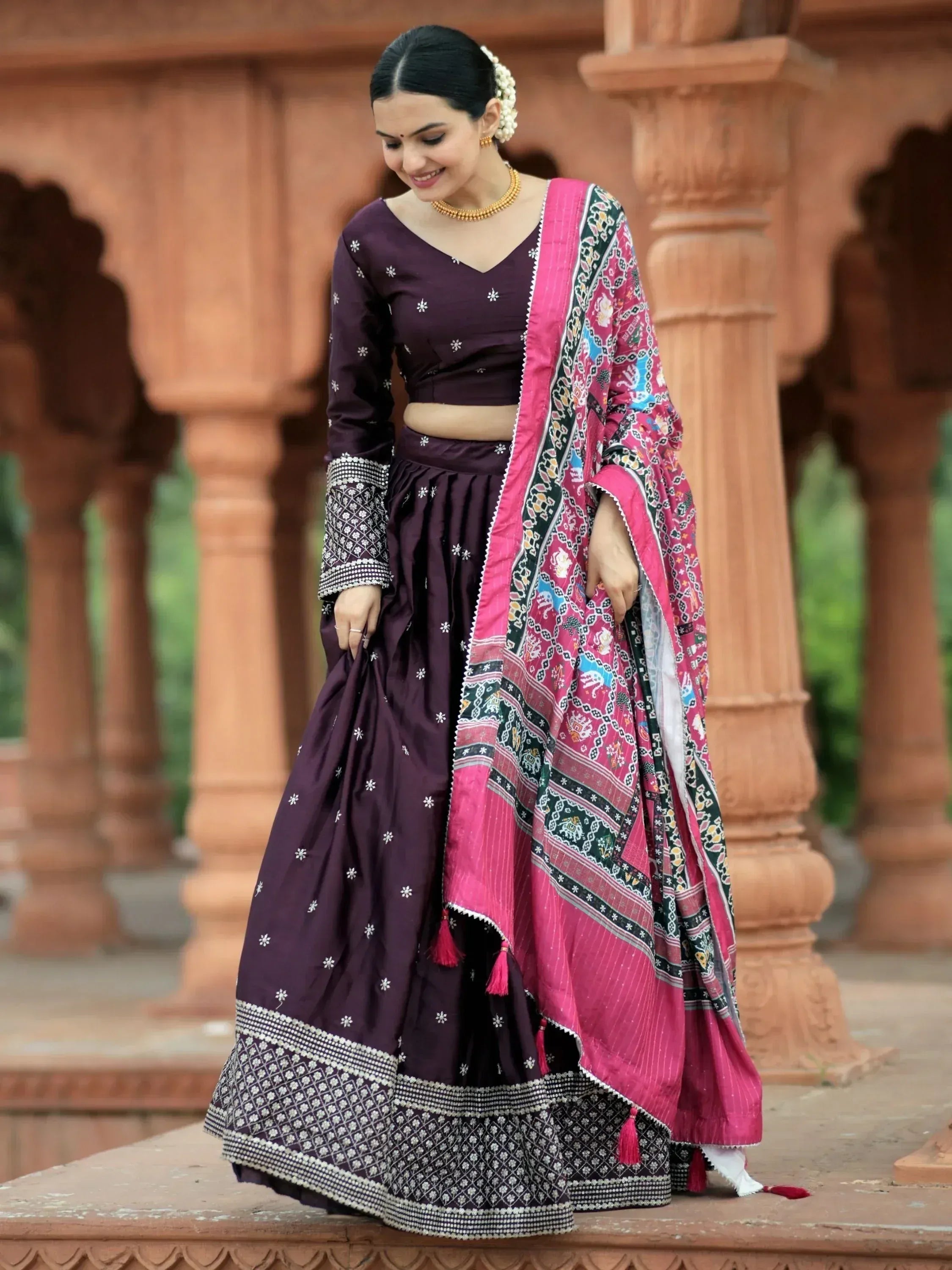 Woman in purple embroidered lehenga choli with pink printed dupatta, traditional Indian ethnic wear