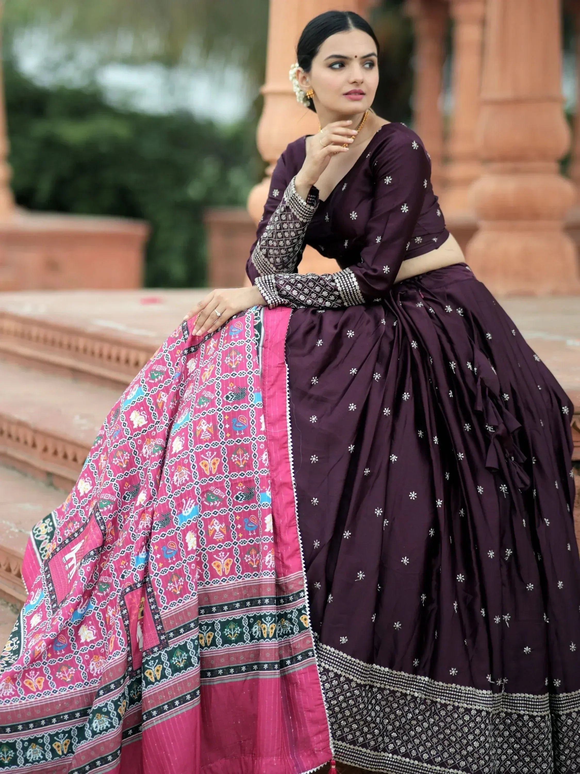 Elegant purple lehenga choli with floral embroidery and vibrant pink dupatta, perfect for Indian ethnic occasions.