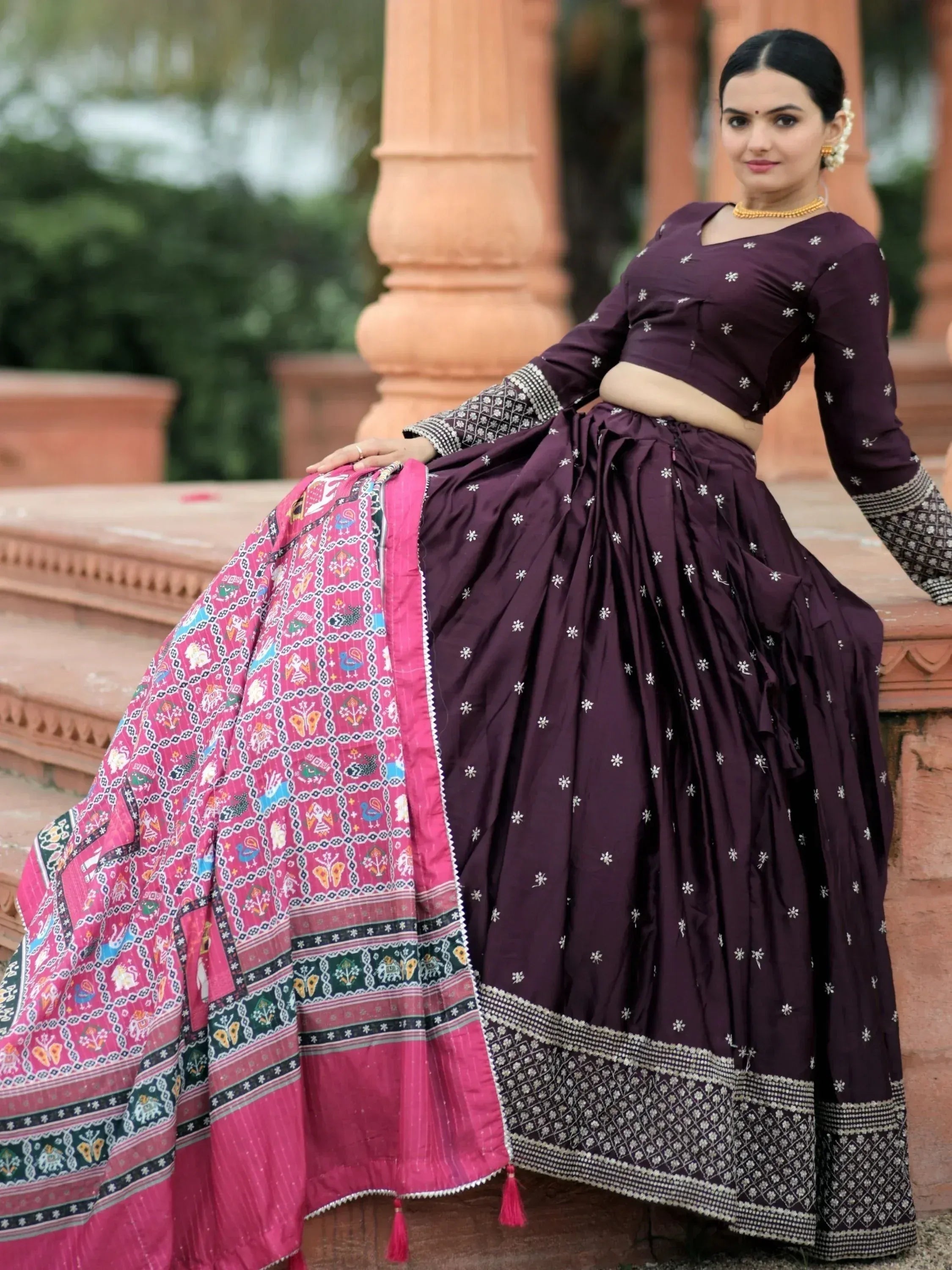 Elegant purple lehenga choli with floral embroidery and vibrant pink dupatta, perfect for Indian ethnic occasions.