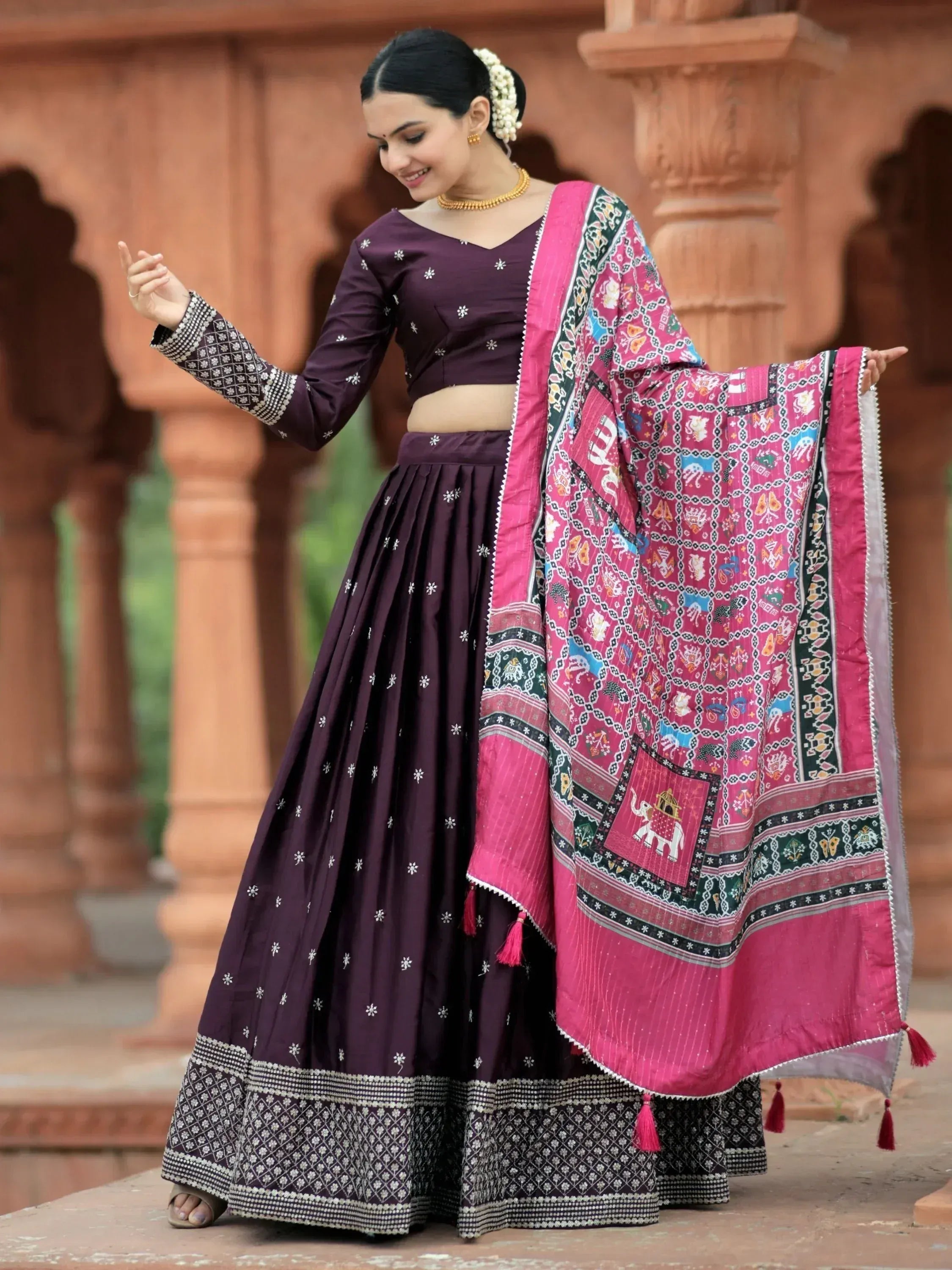 Woman in purple embroidered lehenga choli with pink printed dupatta, traditional Indian ethnic wear